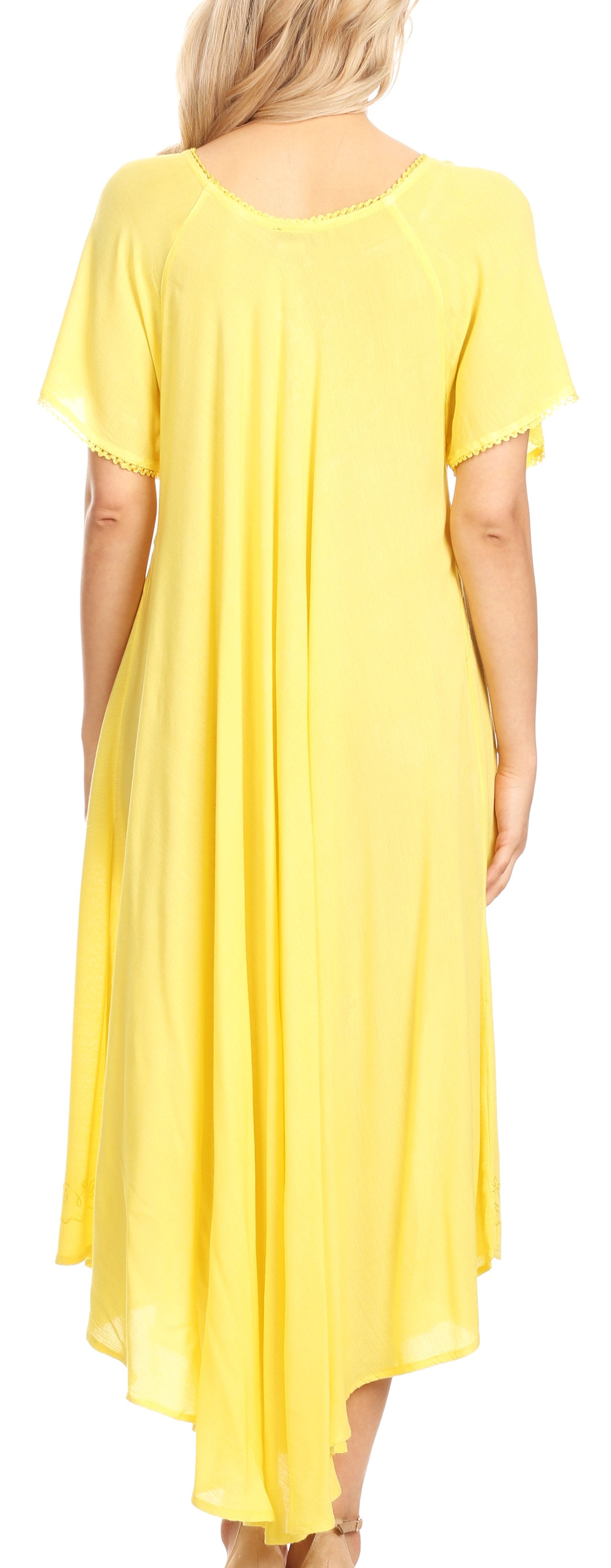 Woman wearing a yellow dress with short sleeves and a flowing skirt.