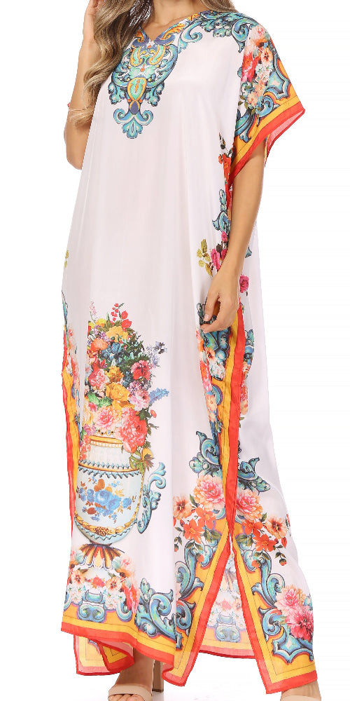 Woman wearing a long, floral-patterned dress with a colorful border on a white background