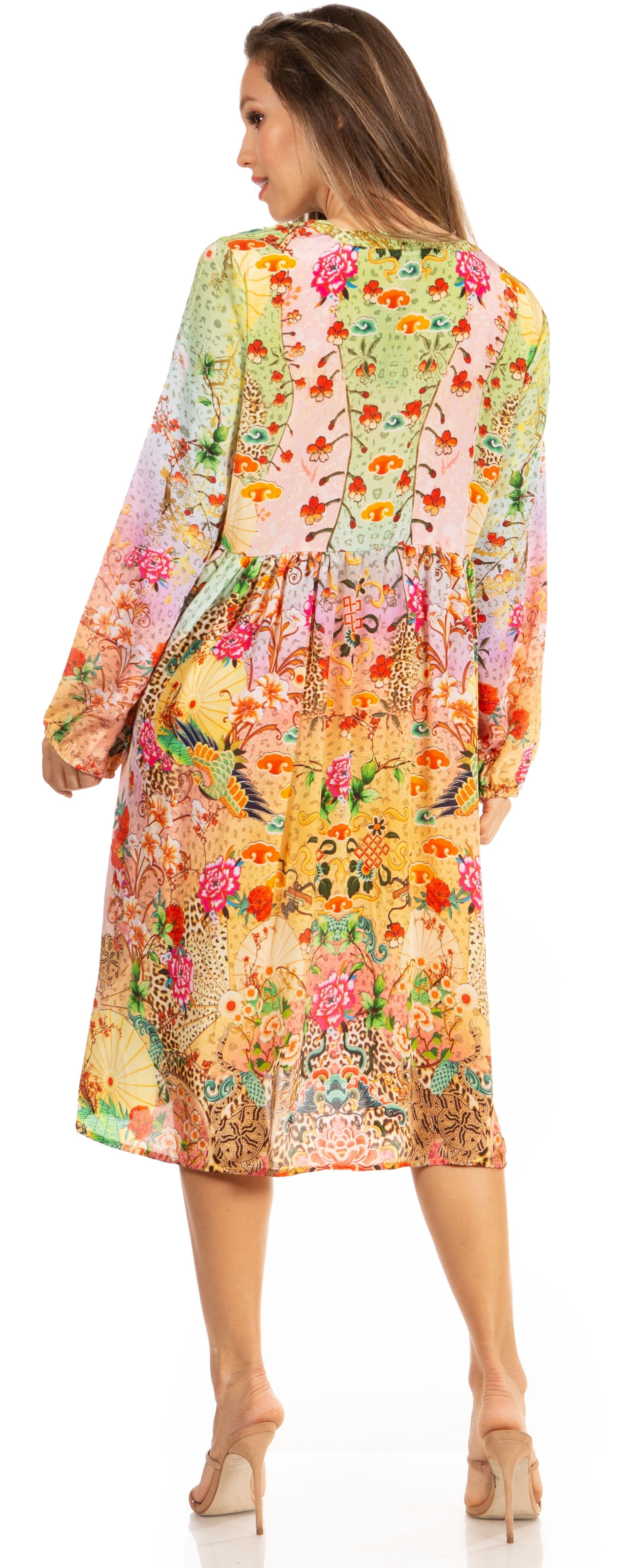 Woman wearing a colorful floral dress with long sleeves.