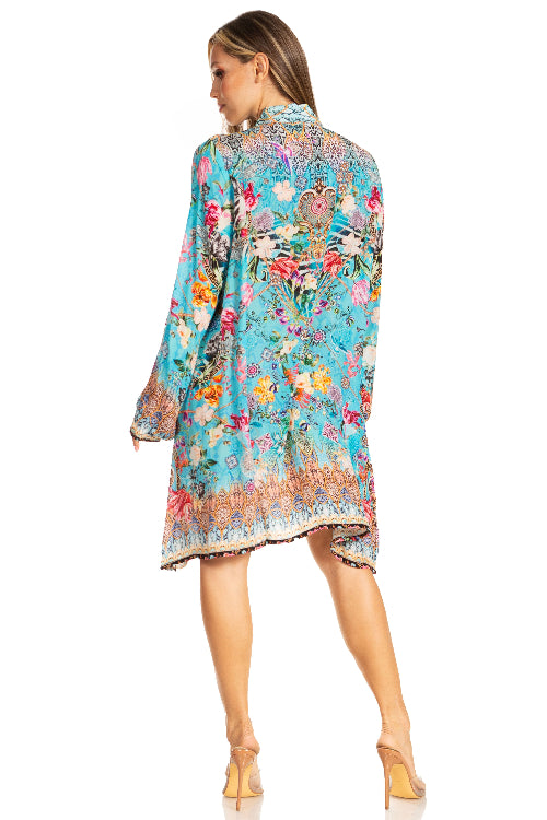 Woman wearing a colorful floral dress on a white background