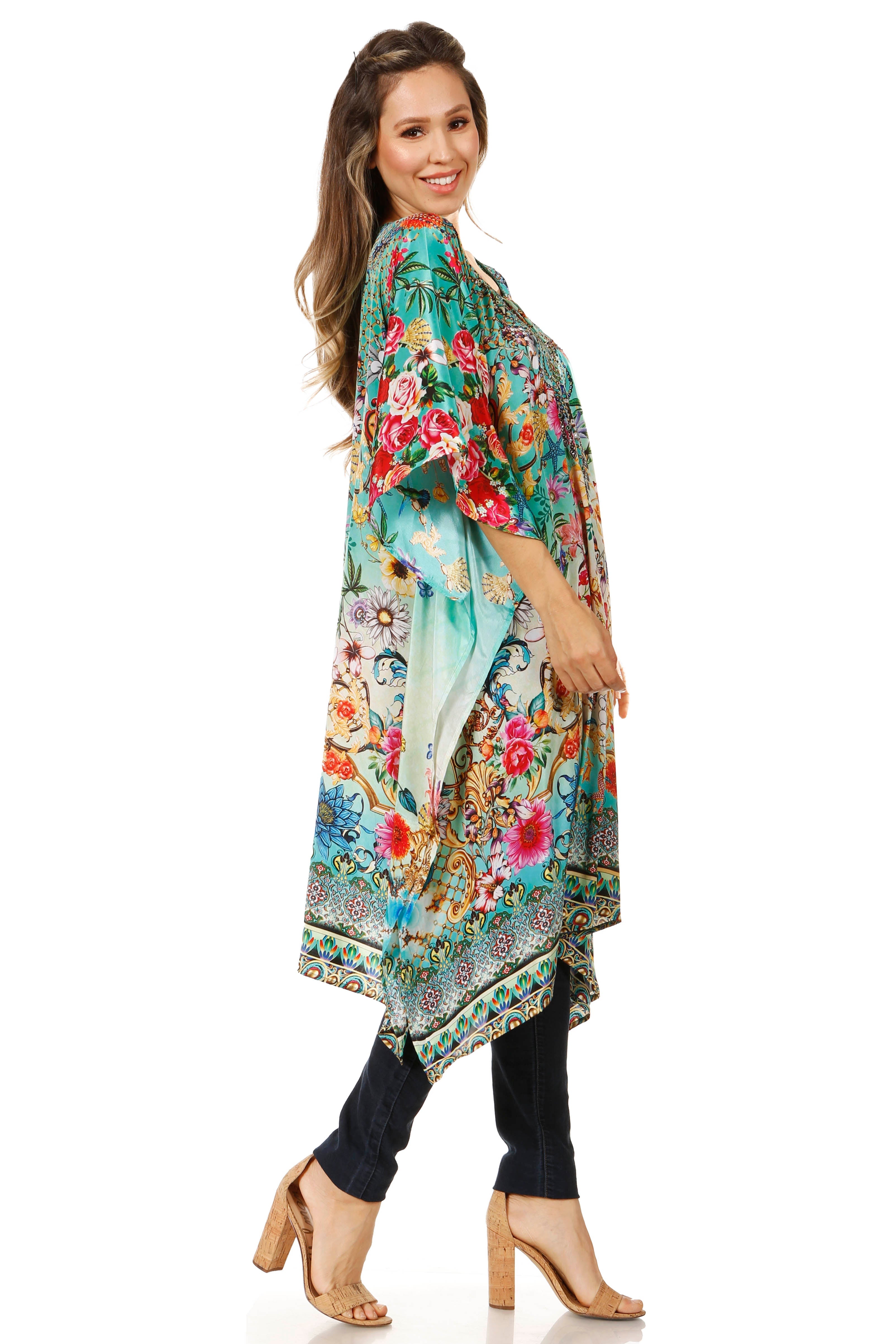 Woman wearing a colorful floral kimono-style garment on a white background