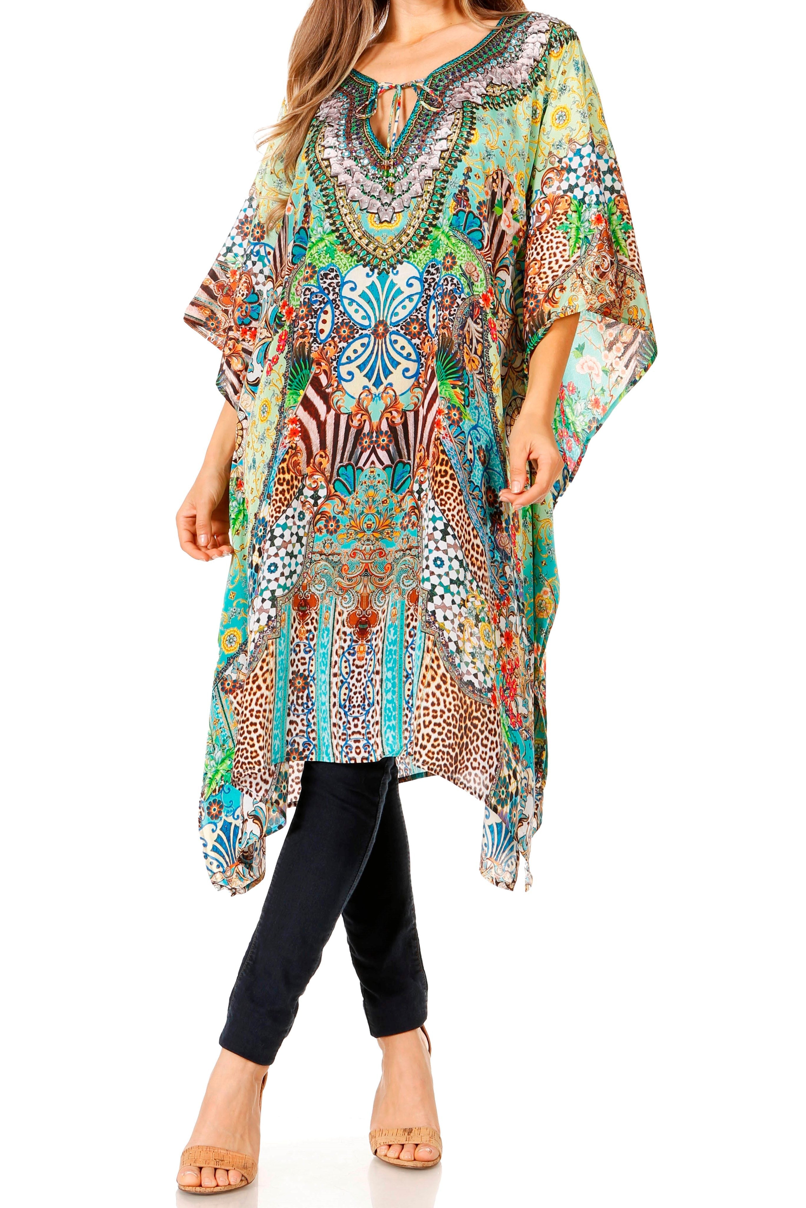 Woman wearing a colorful patterned kaftan over black pants on a white background