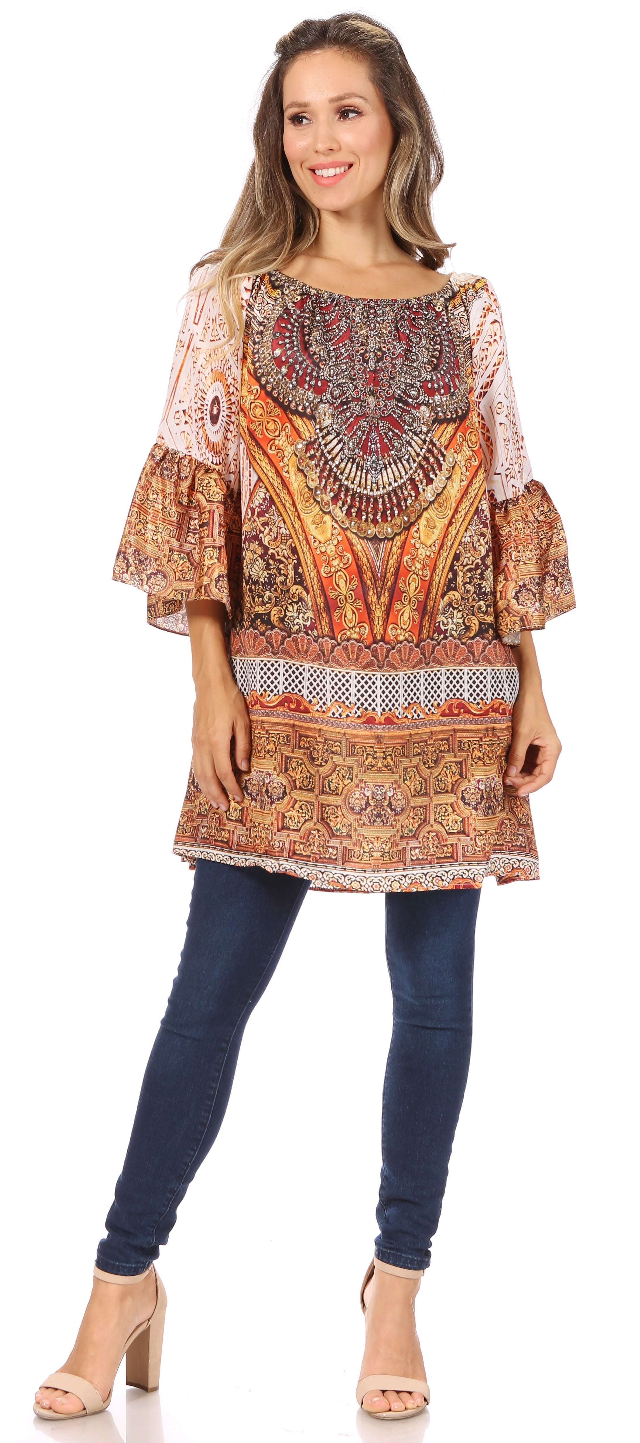 Woman wearing a patterned top and blue jeans on a white background