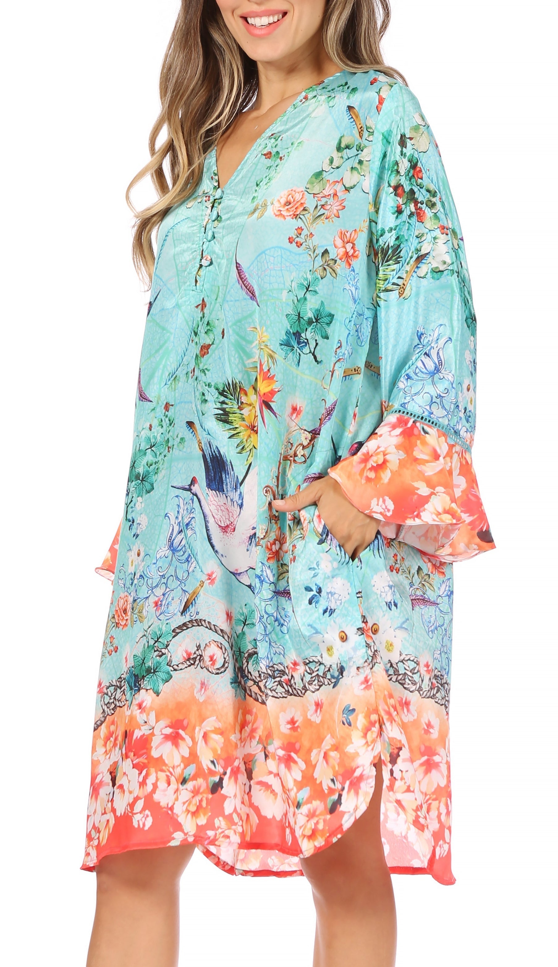 Woman wearing a colorful floral dress with bell sleeves on a white background