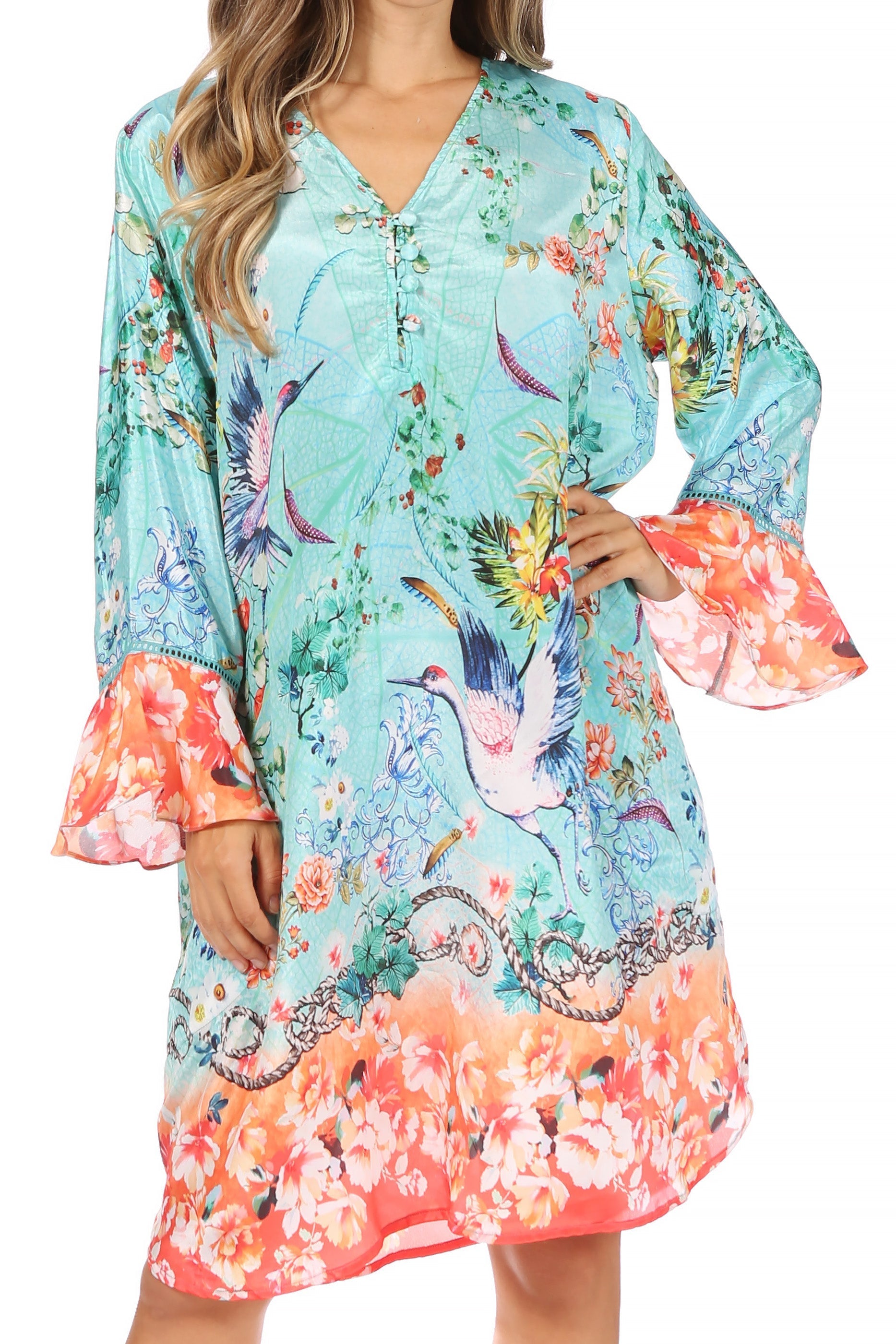 Woman wearing a colorful floral dress with bird patterns on a white background