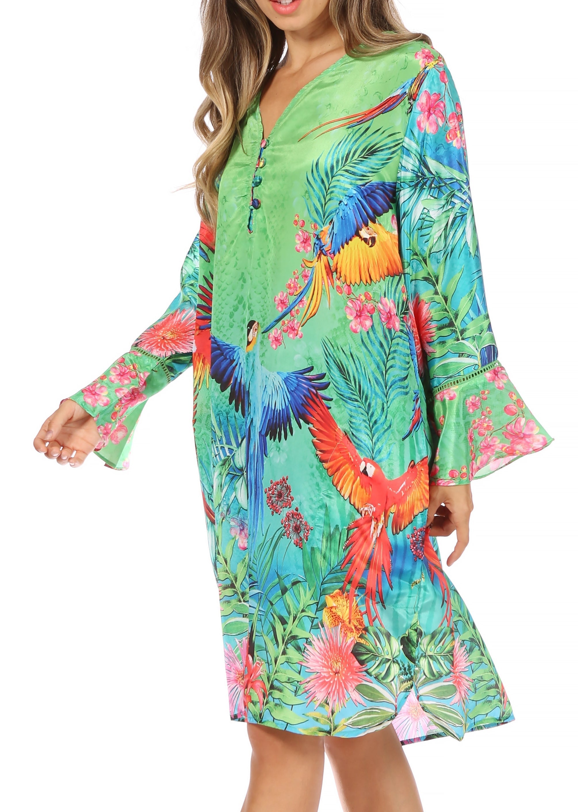 Woman wearing a colorful tropical dress with parrot and floral patterns on a white background