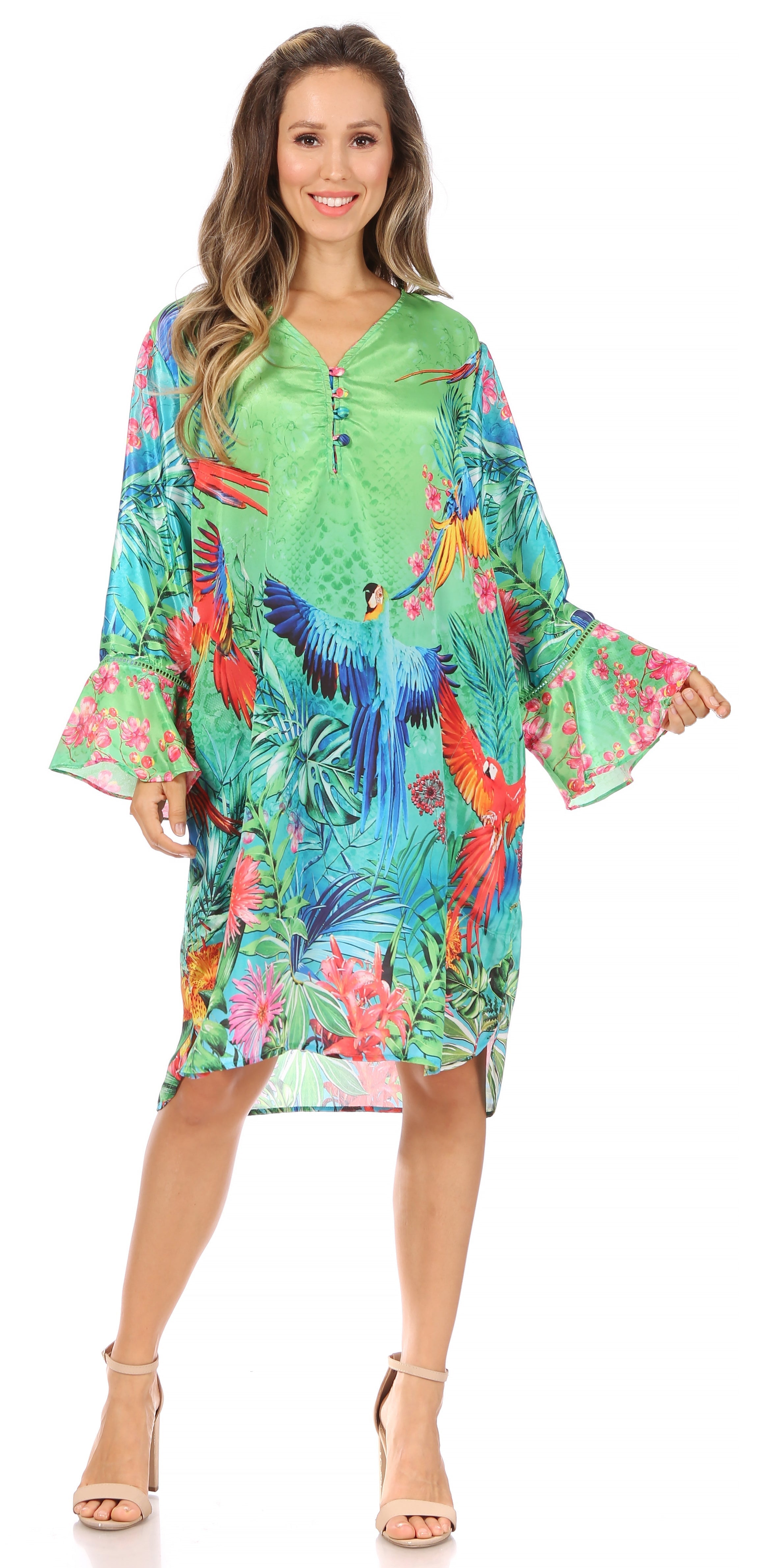 Woman wearing a colorful tropical print dress on a white background