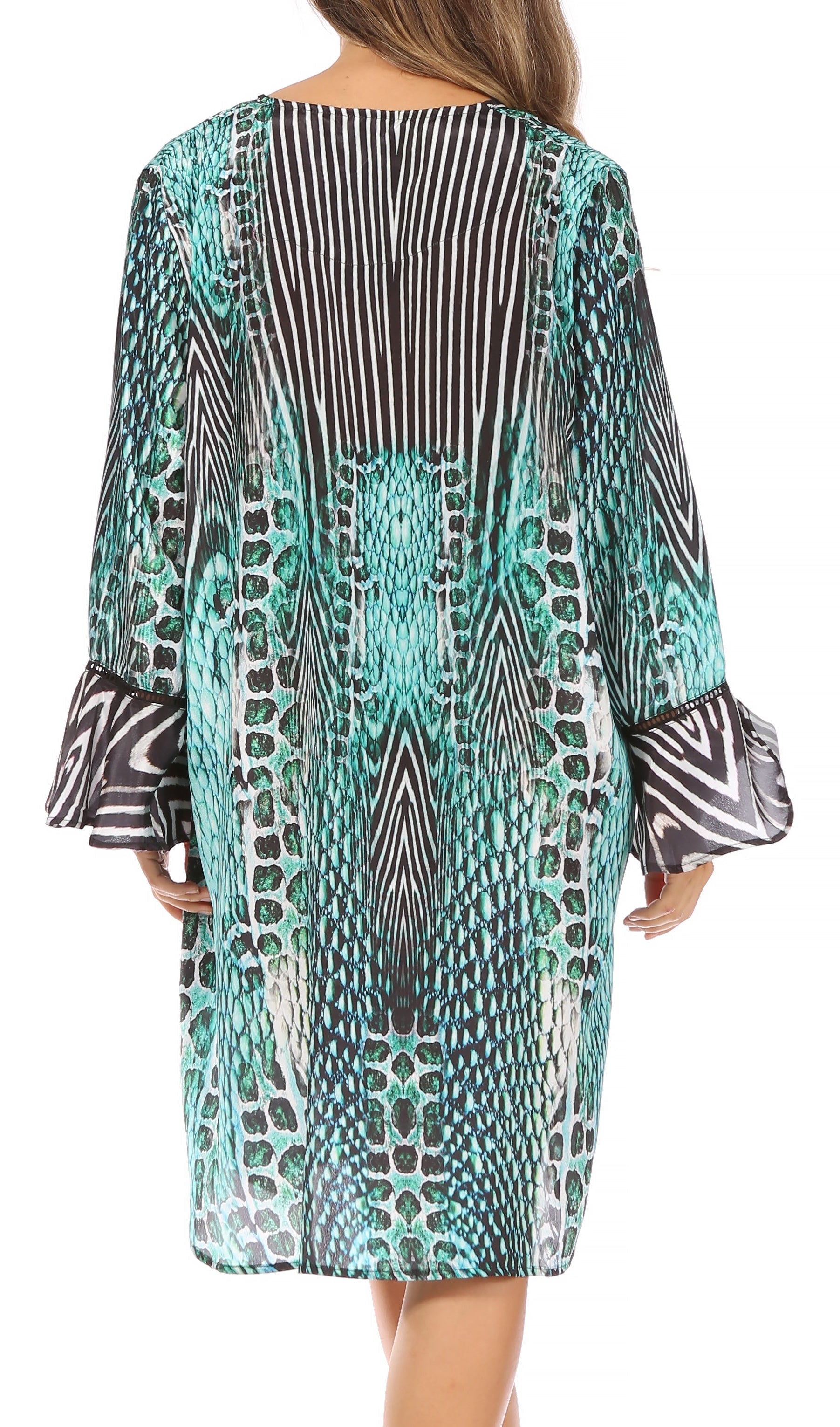 Woman wearing a patterned dress with long sleeves on a white background