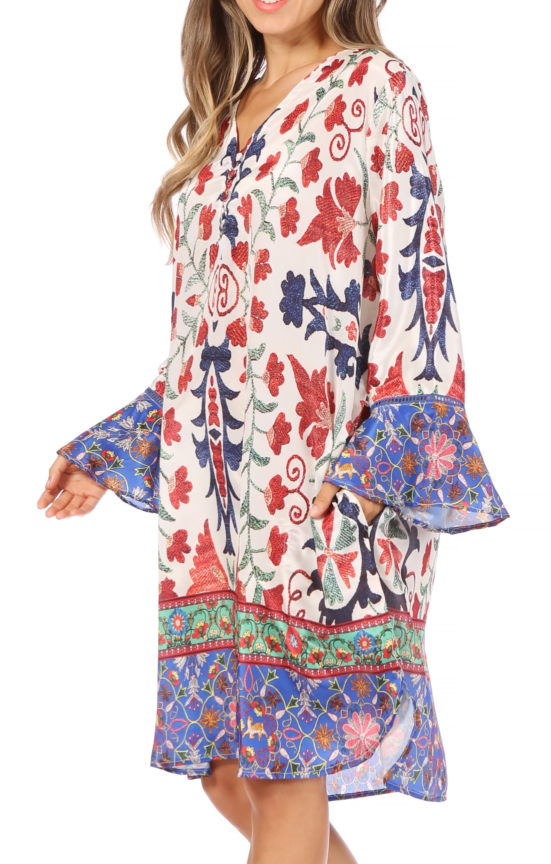 Woman wearing a colorful floral dress with bell sleeves on a white background