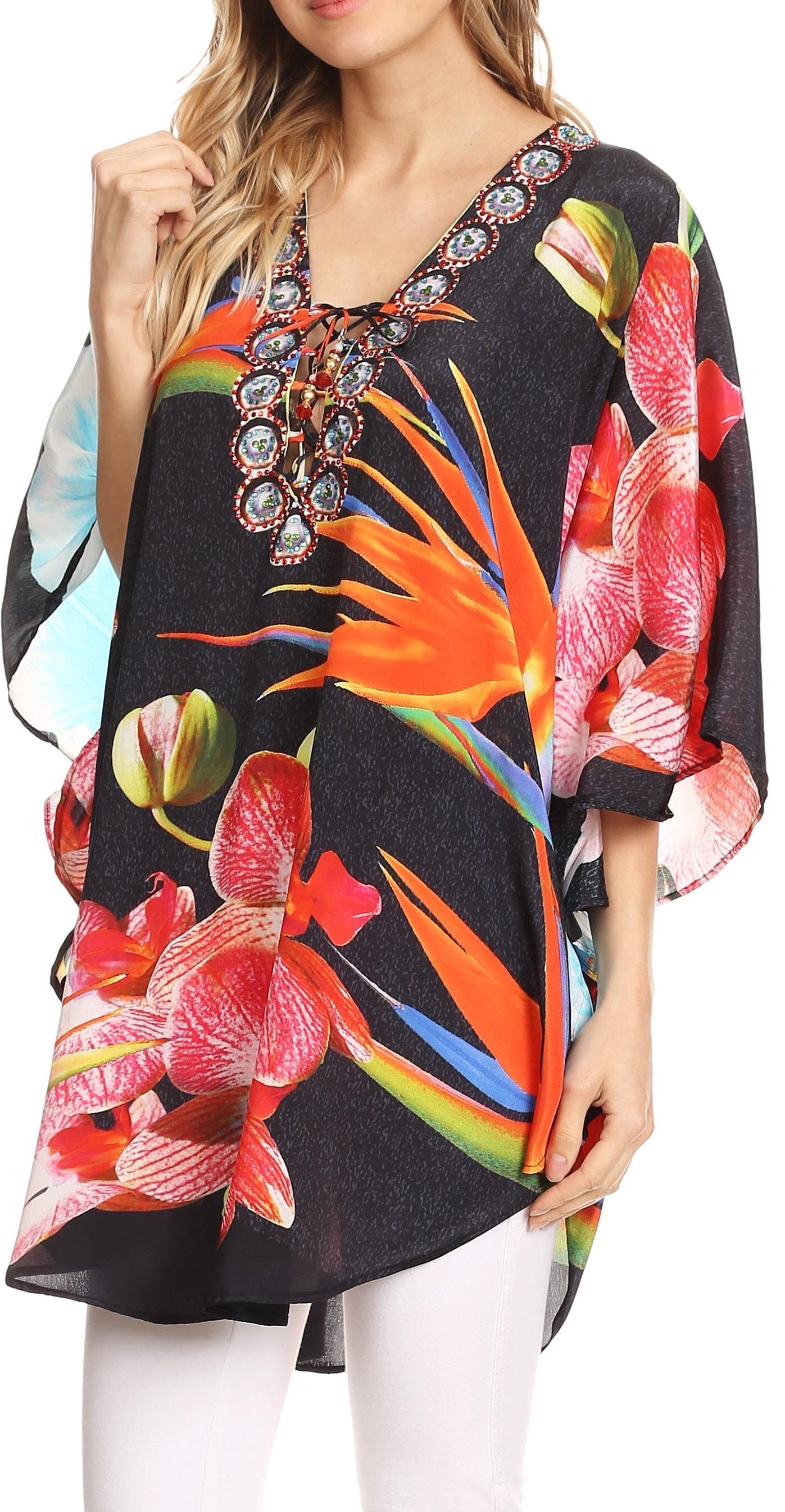 Woman wearing a colorful floral blouse with a black background