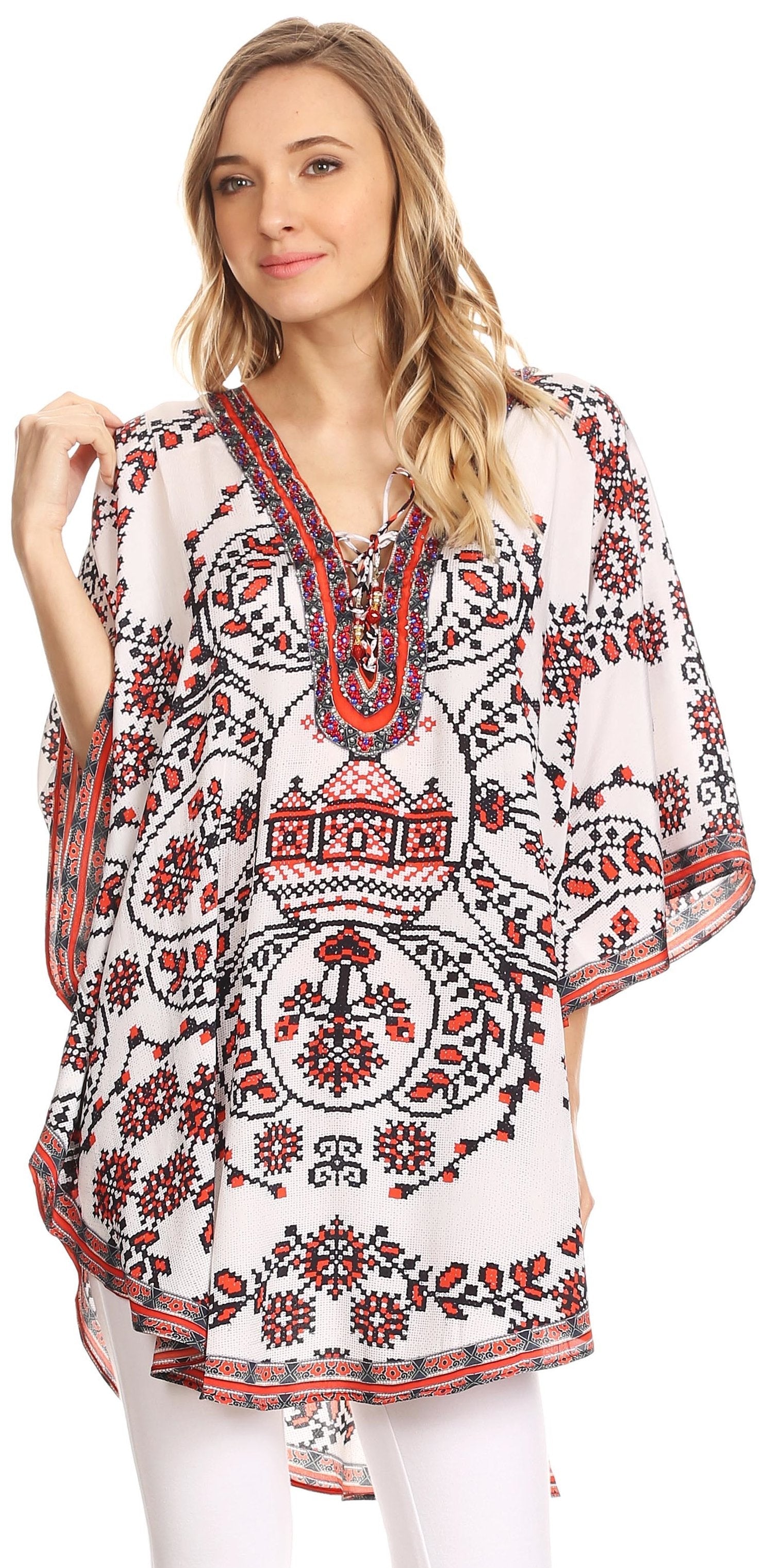 Woman wearing a white blouse with red and black floral patterns on a white background