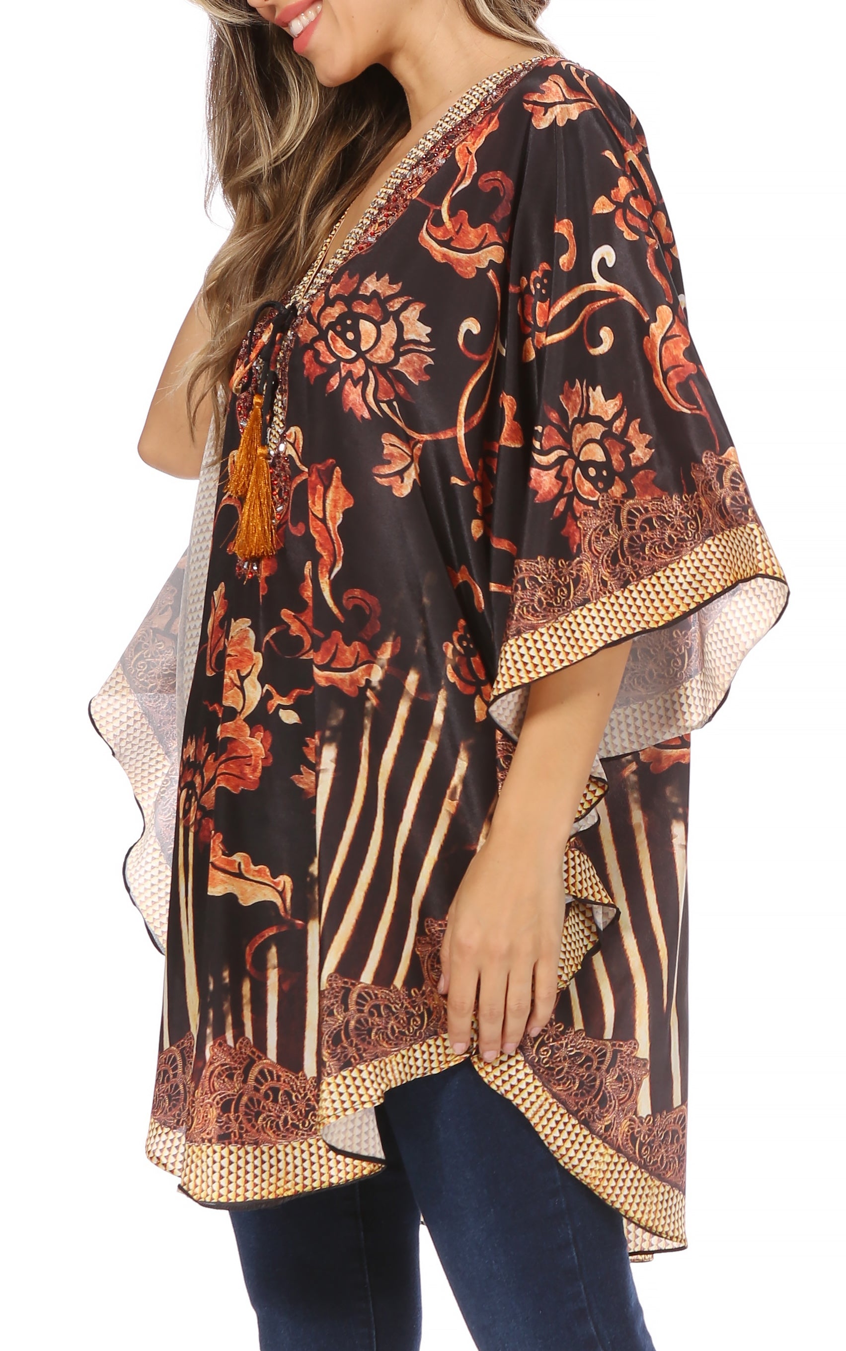 Woman wearing a patterned kimono-style top with floral designs on a white background