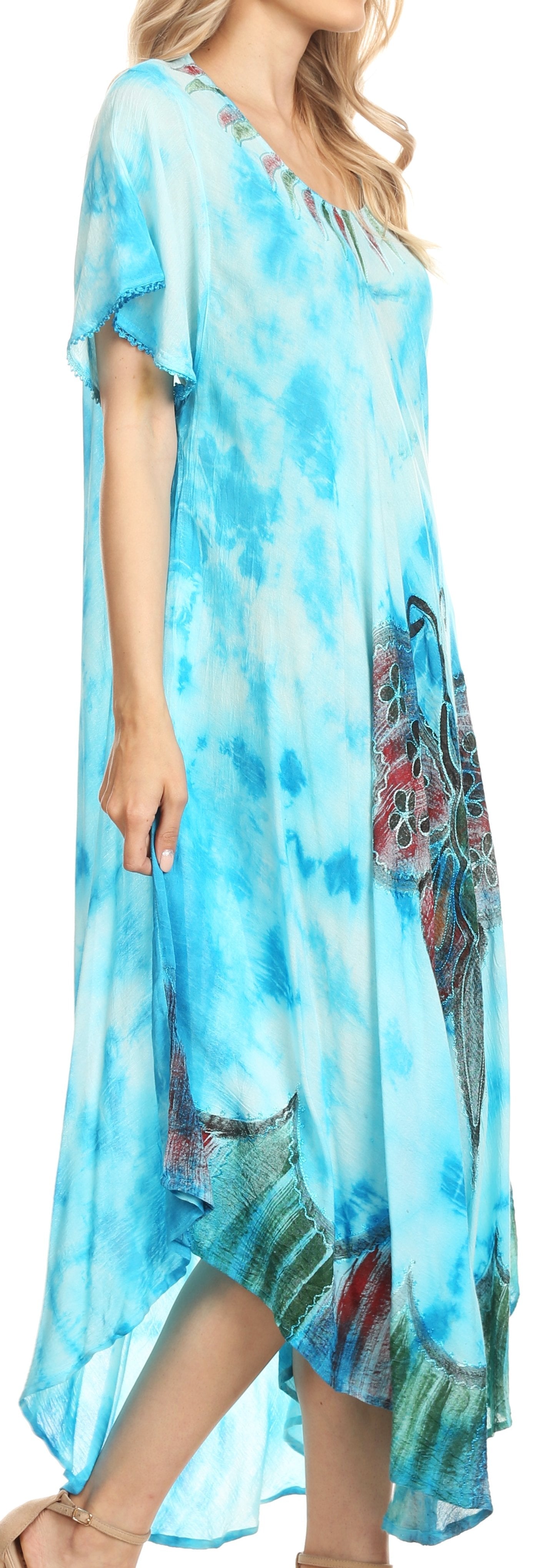 Woman wearing a blue tie-dye dress with floral patterns.