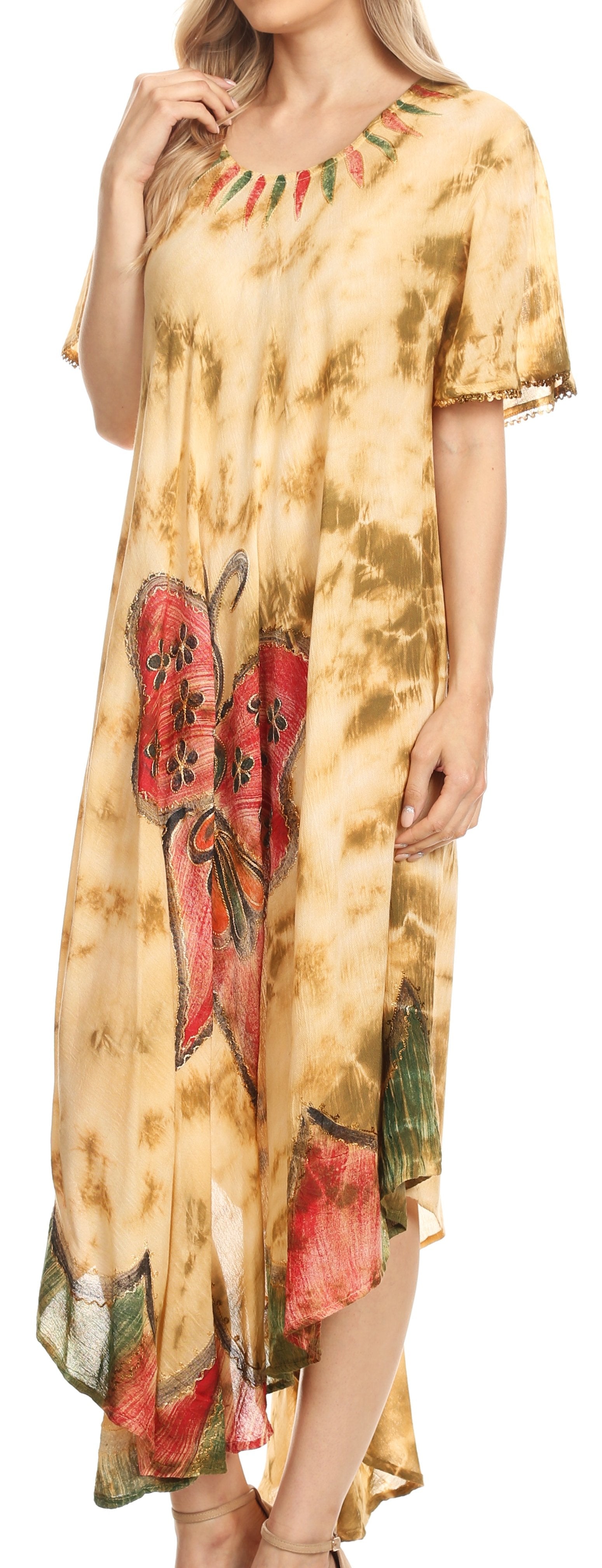 Woman wearing a tie-dye dress with butterfly designs on a plain background
