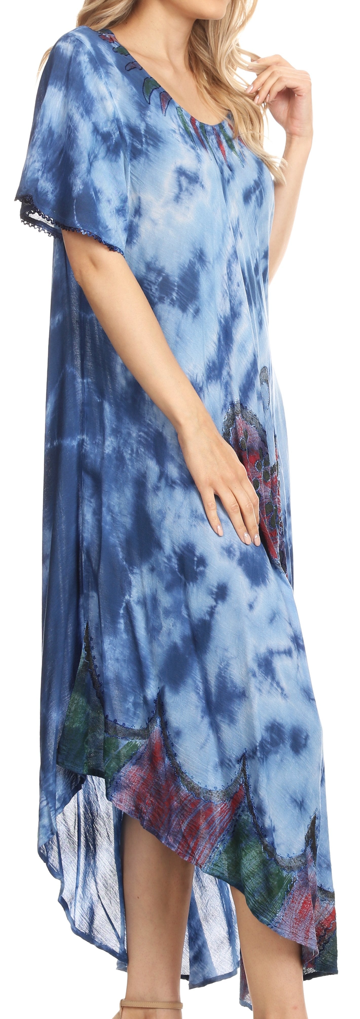 Woman wearing a blue tie-dye dress with a floral pattern.