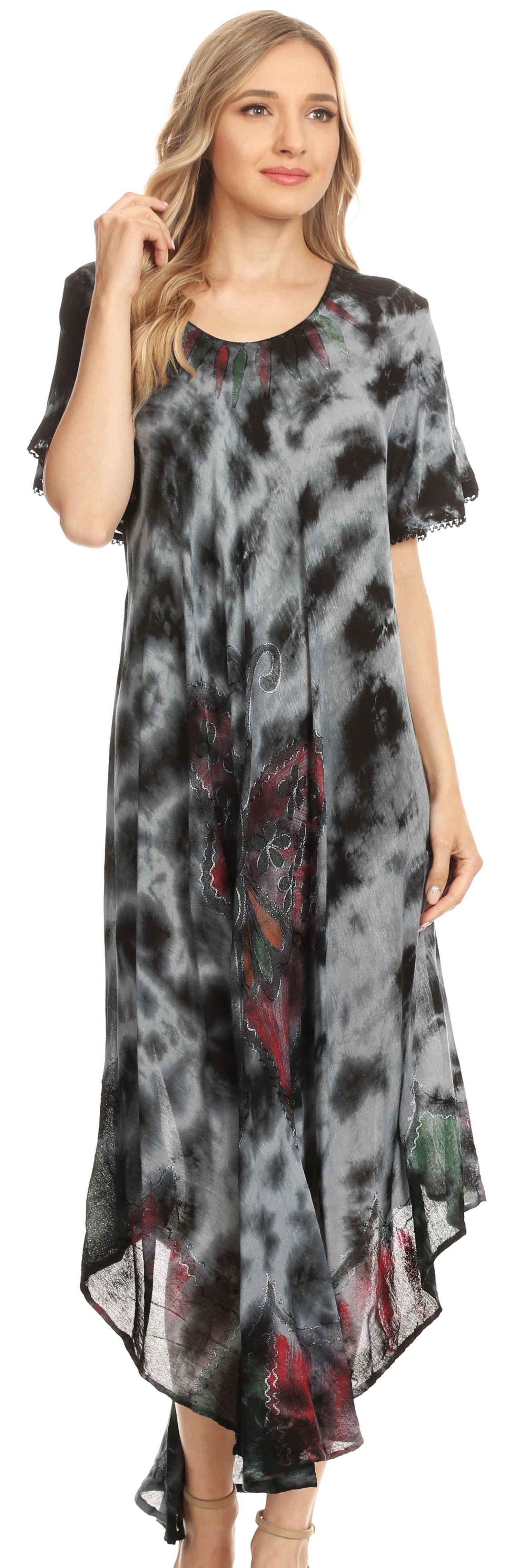 Woman wearing a patterned dress with a high-low hem design.