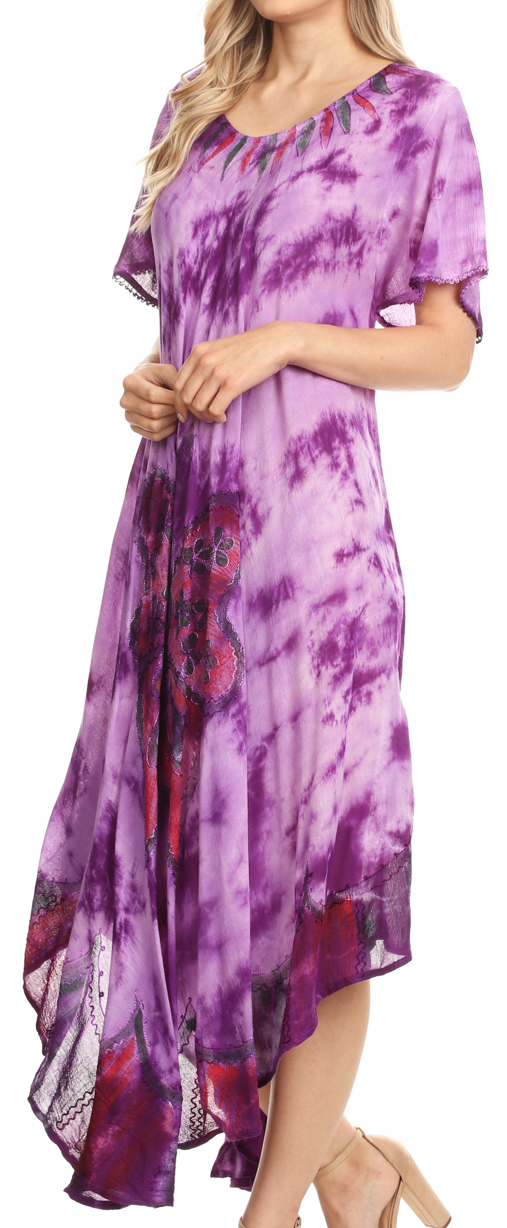 Woman wearing a purple tie-dye dress with a floral pattern.