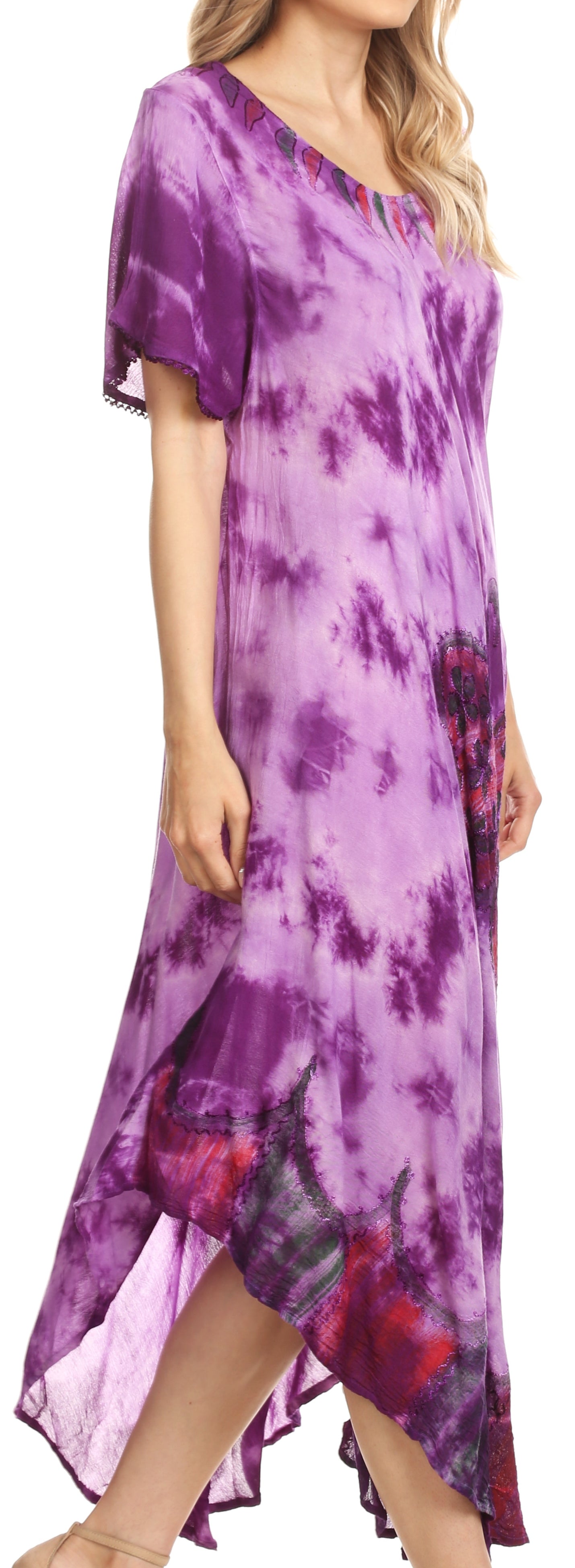 Woman wearing a purple tie-dye dress with floral patterns.