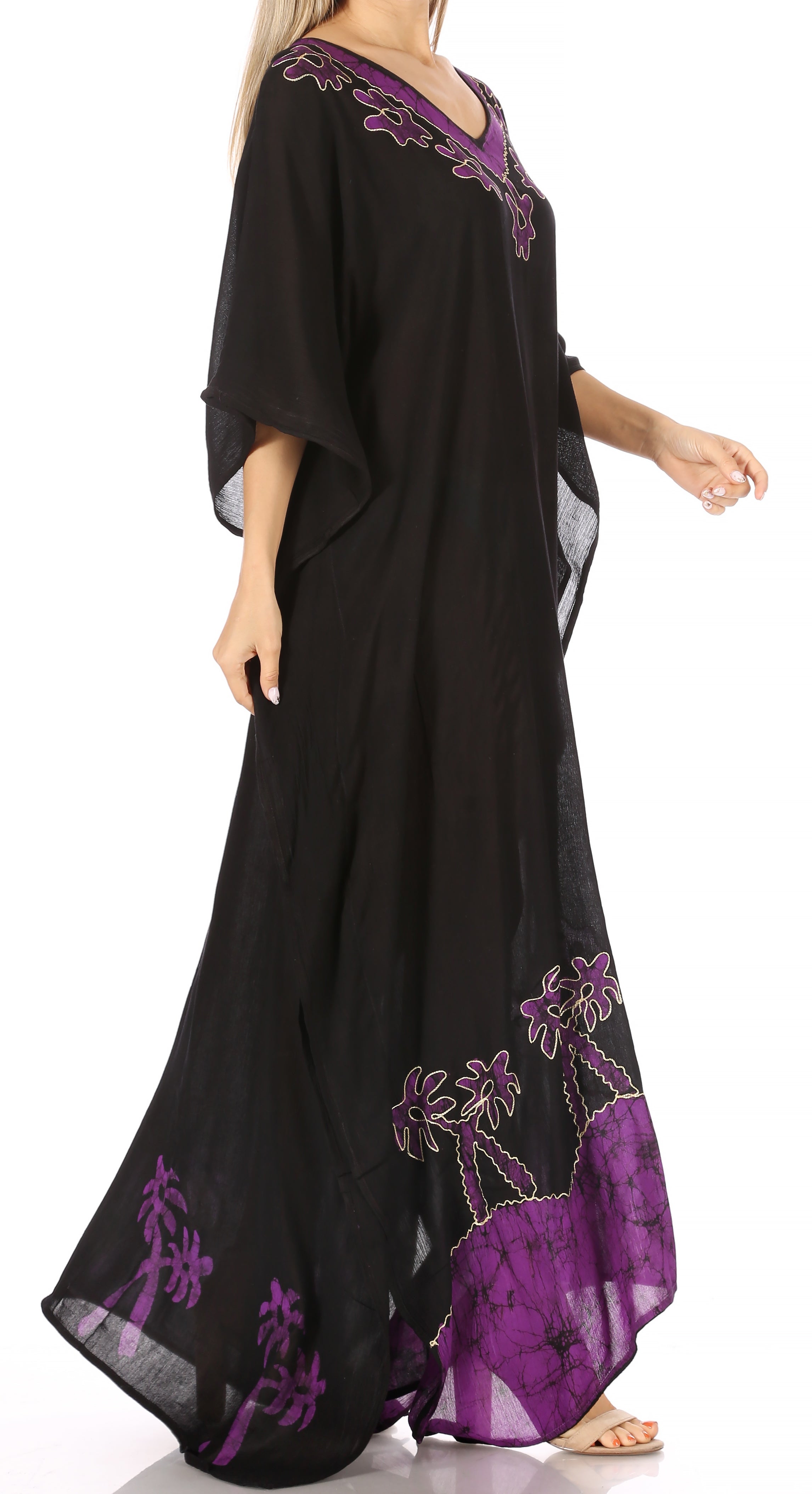 Black dress with purple palm tree embroidery on a white background
