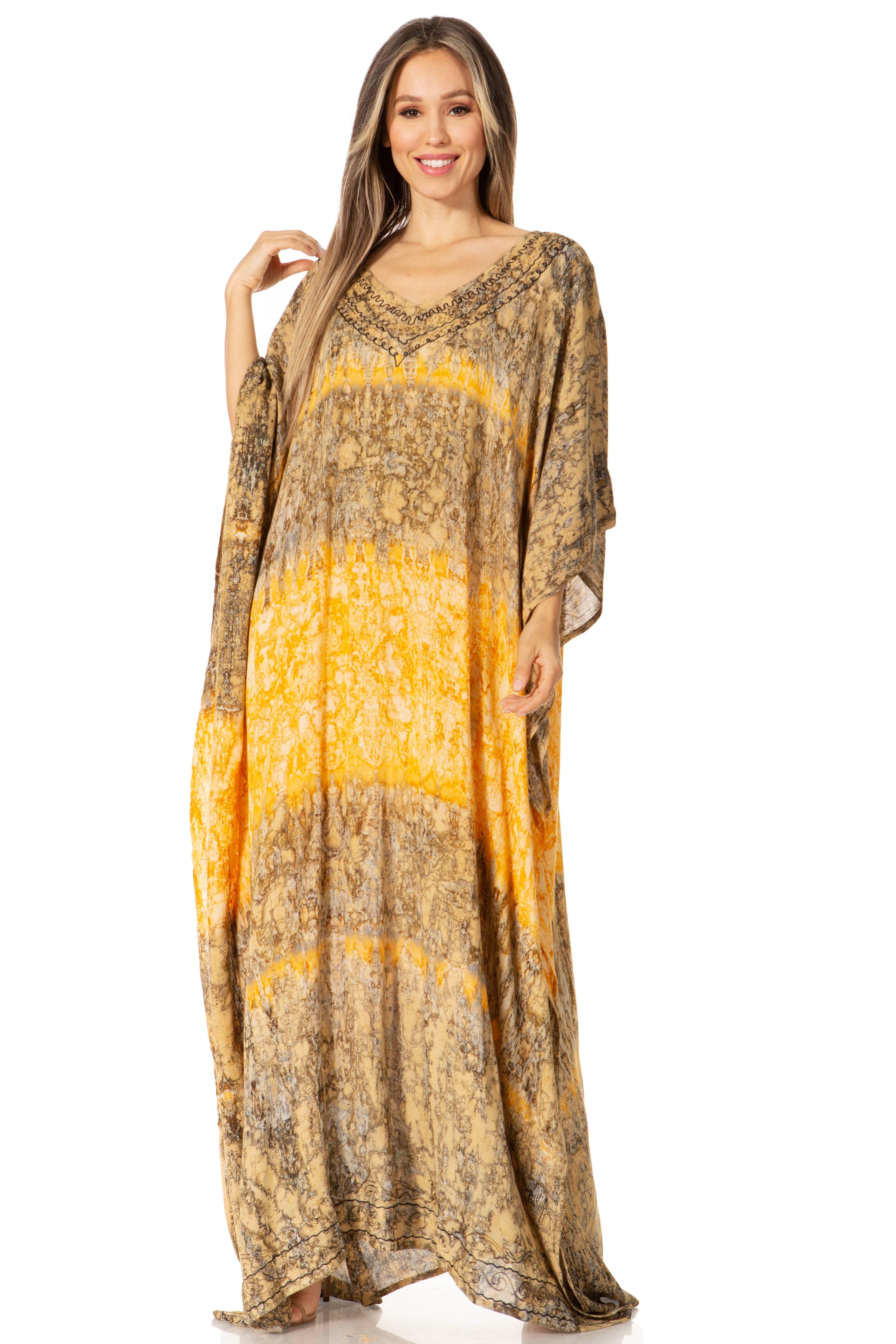 Woman wearing a long, patterned dress with a yellow and brown design on a white background