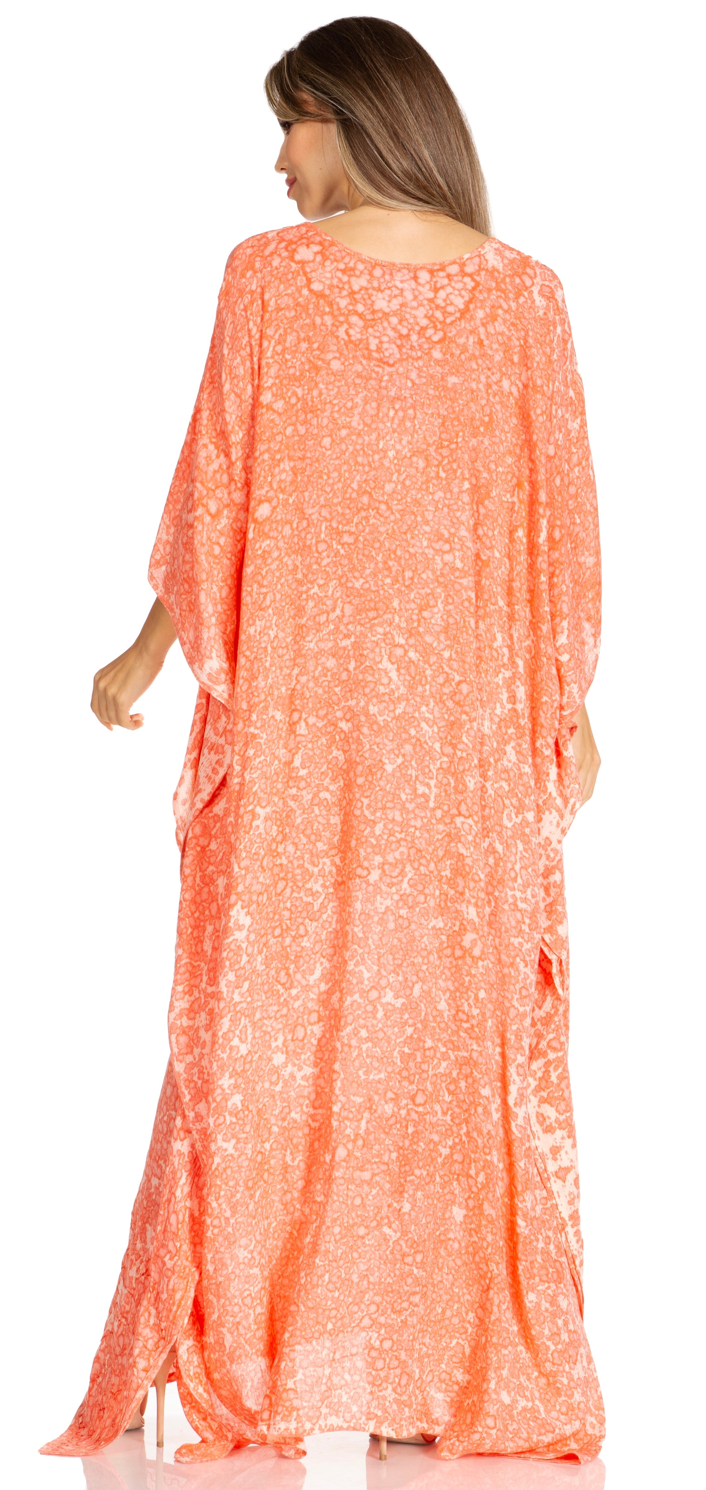 Woman wearing a long, orange floral dress on a white background