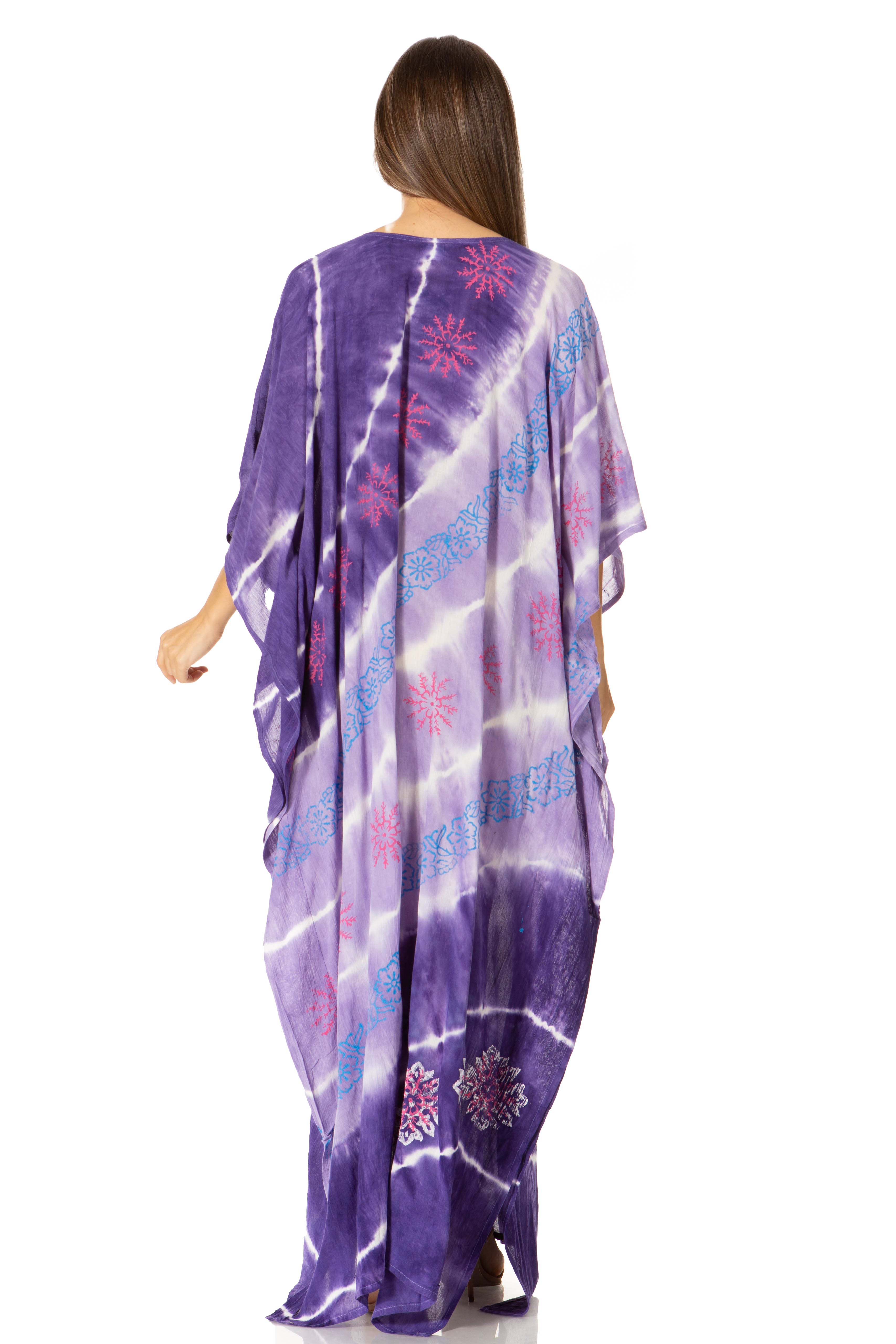 Woman wearing a purple tie-dye dress with floral patterns on a white background