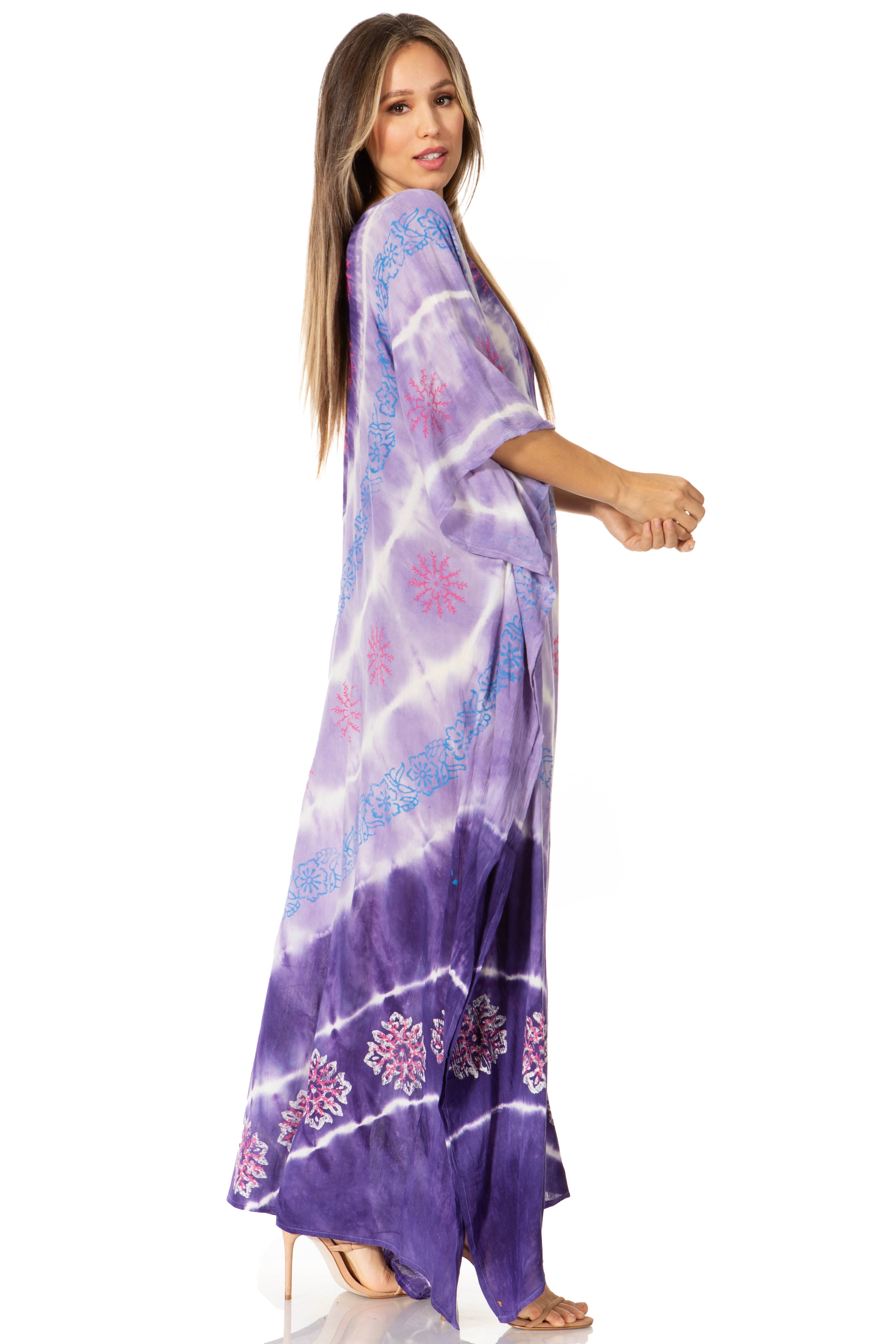 Woman wearing a purple tie-dye dress with floral patterns on a white background