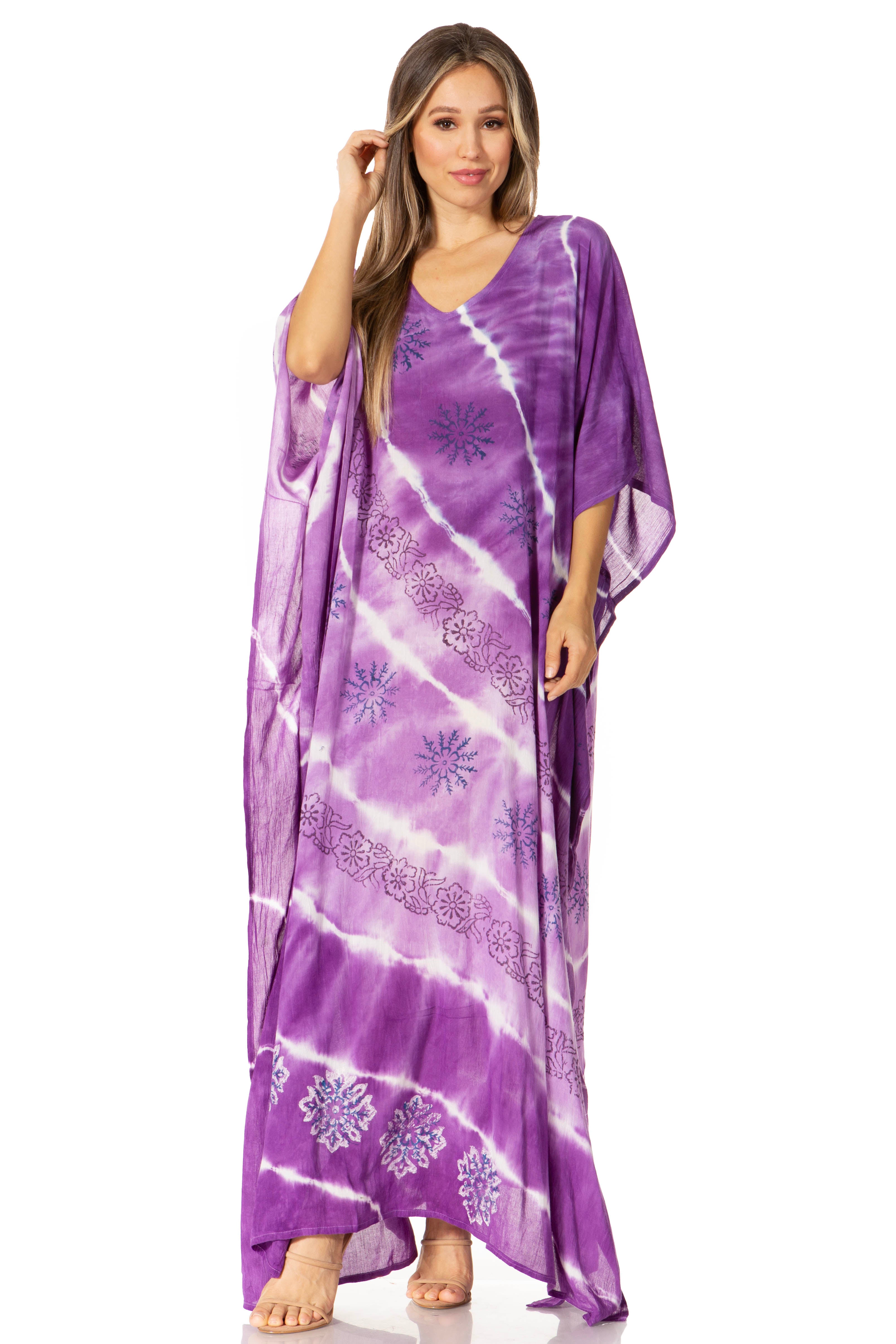 Woman wearing a purple tie-dye dress with floral patterns on a white background