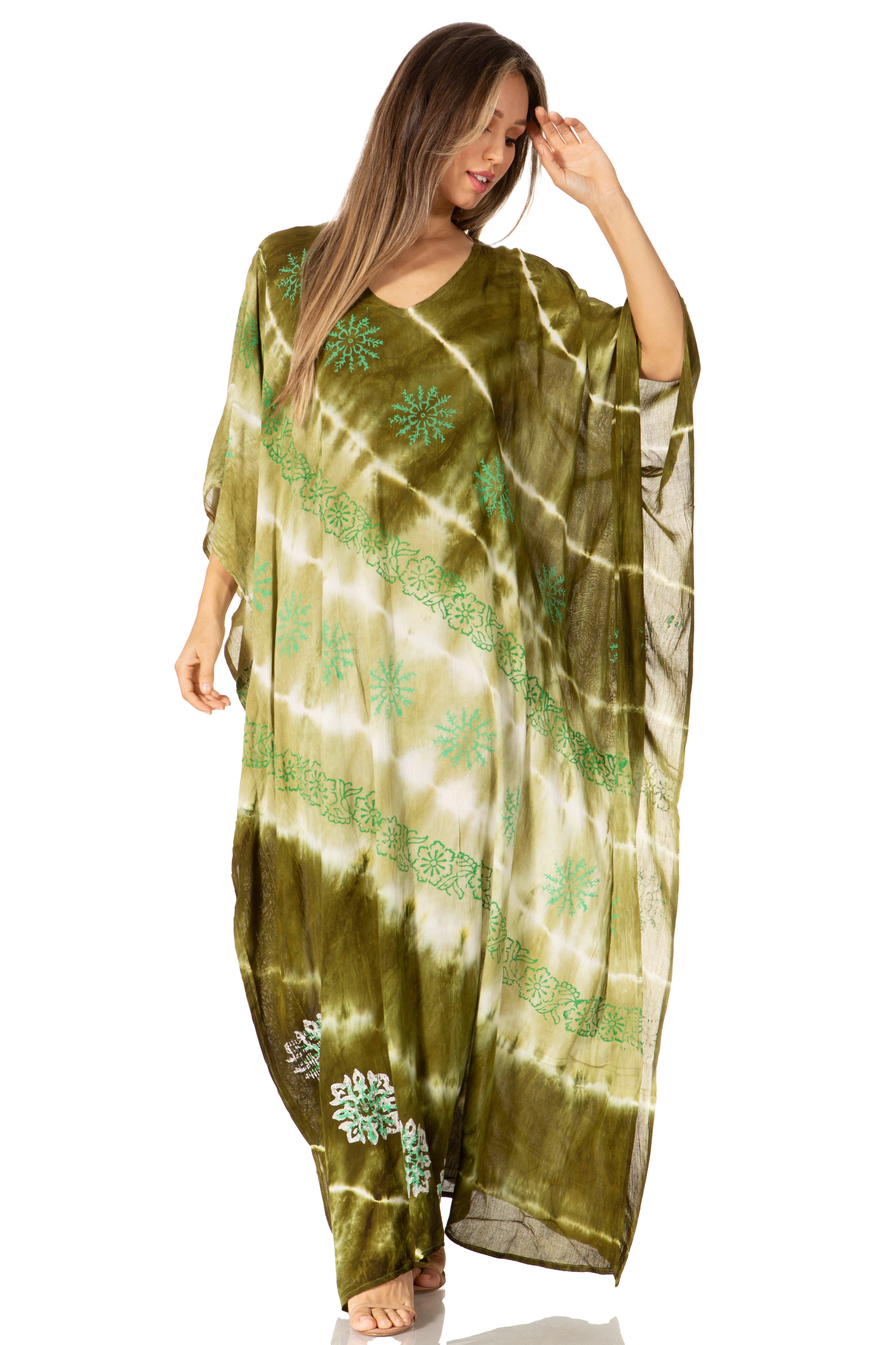 Woman wearing a green tie-dye dress with floral patterns on a white background
