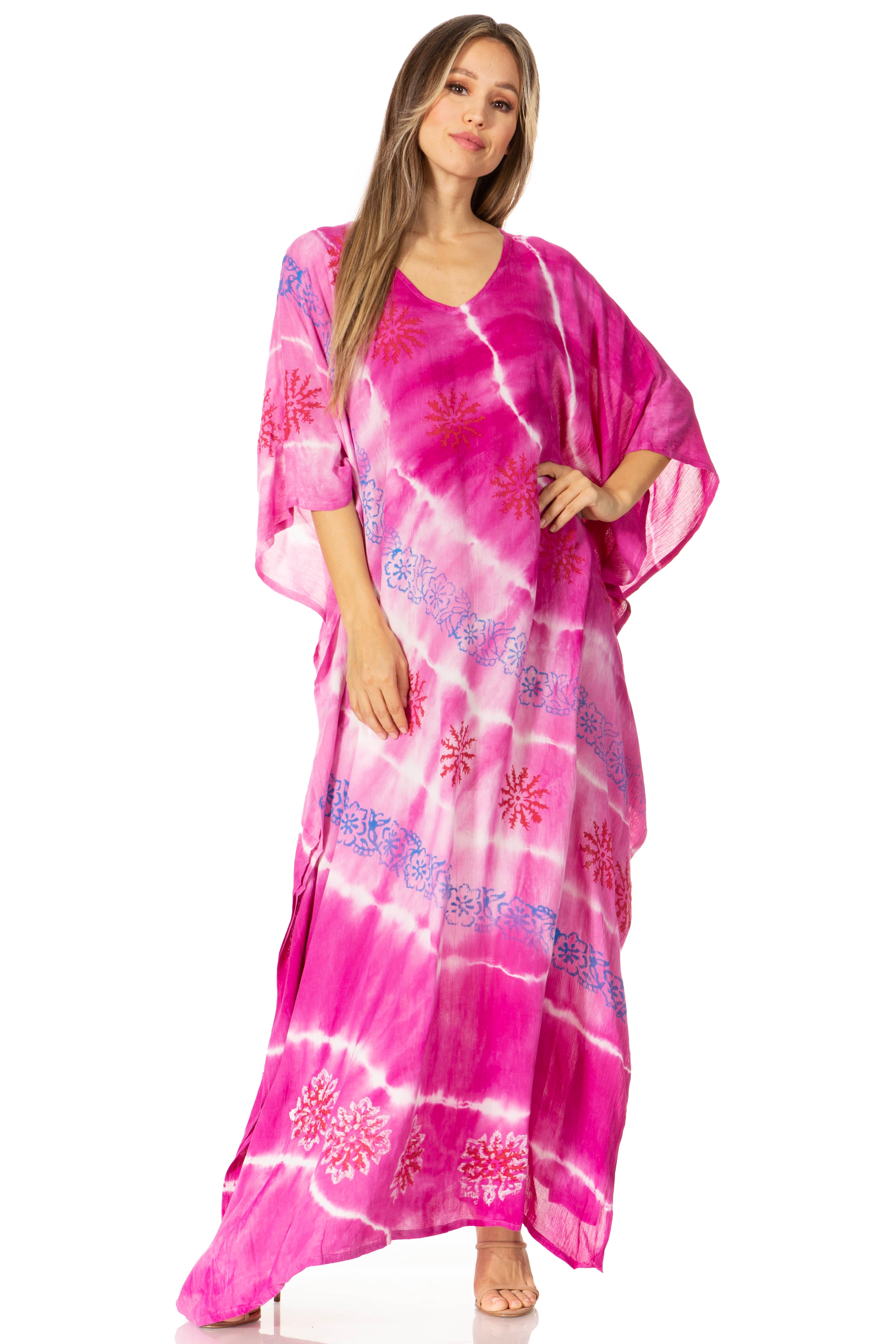 Woman wearing a pink tie-dye dress with floral patterns on a white background