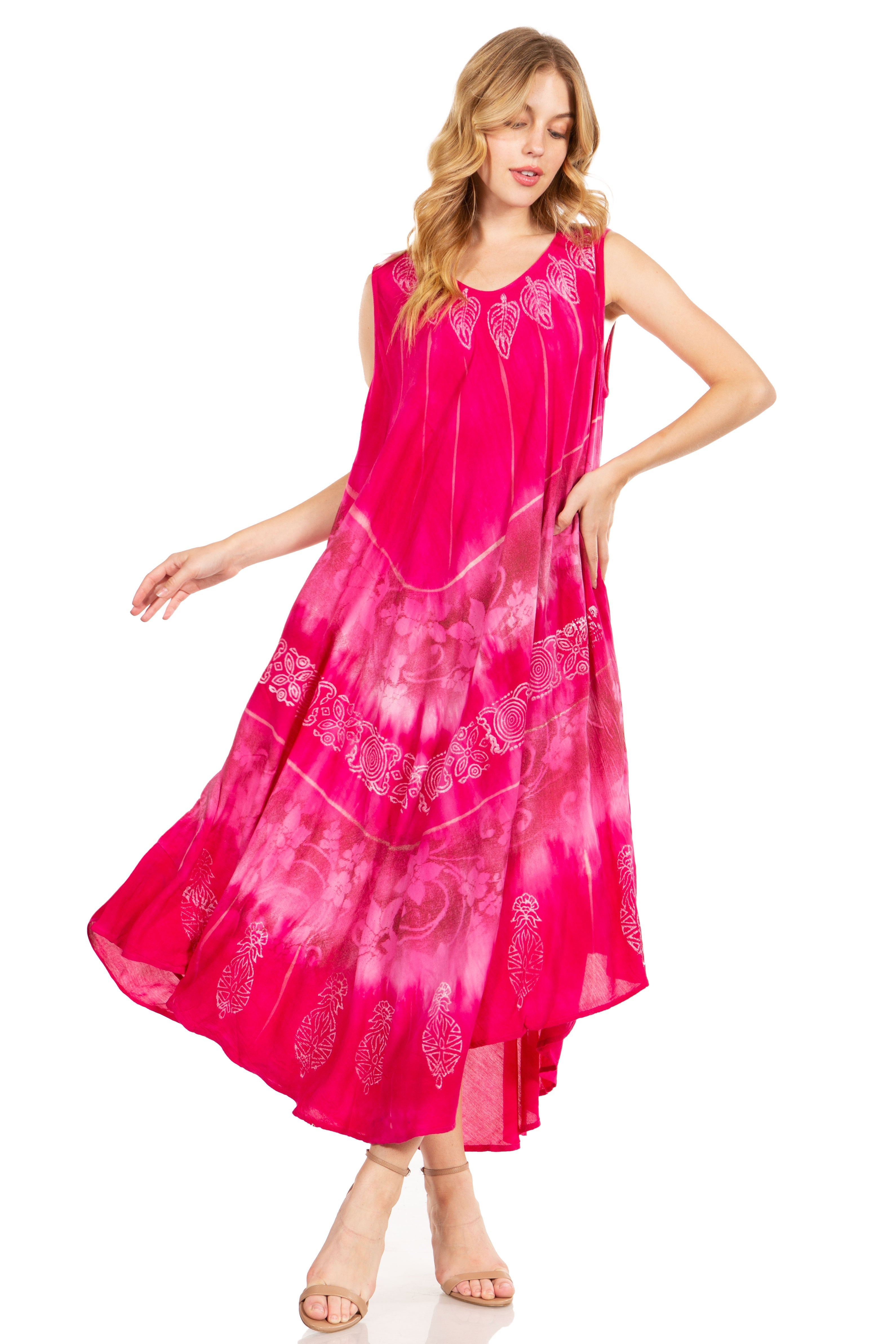 Woman wearing a pink dress with white patterns on a white background