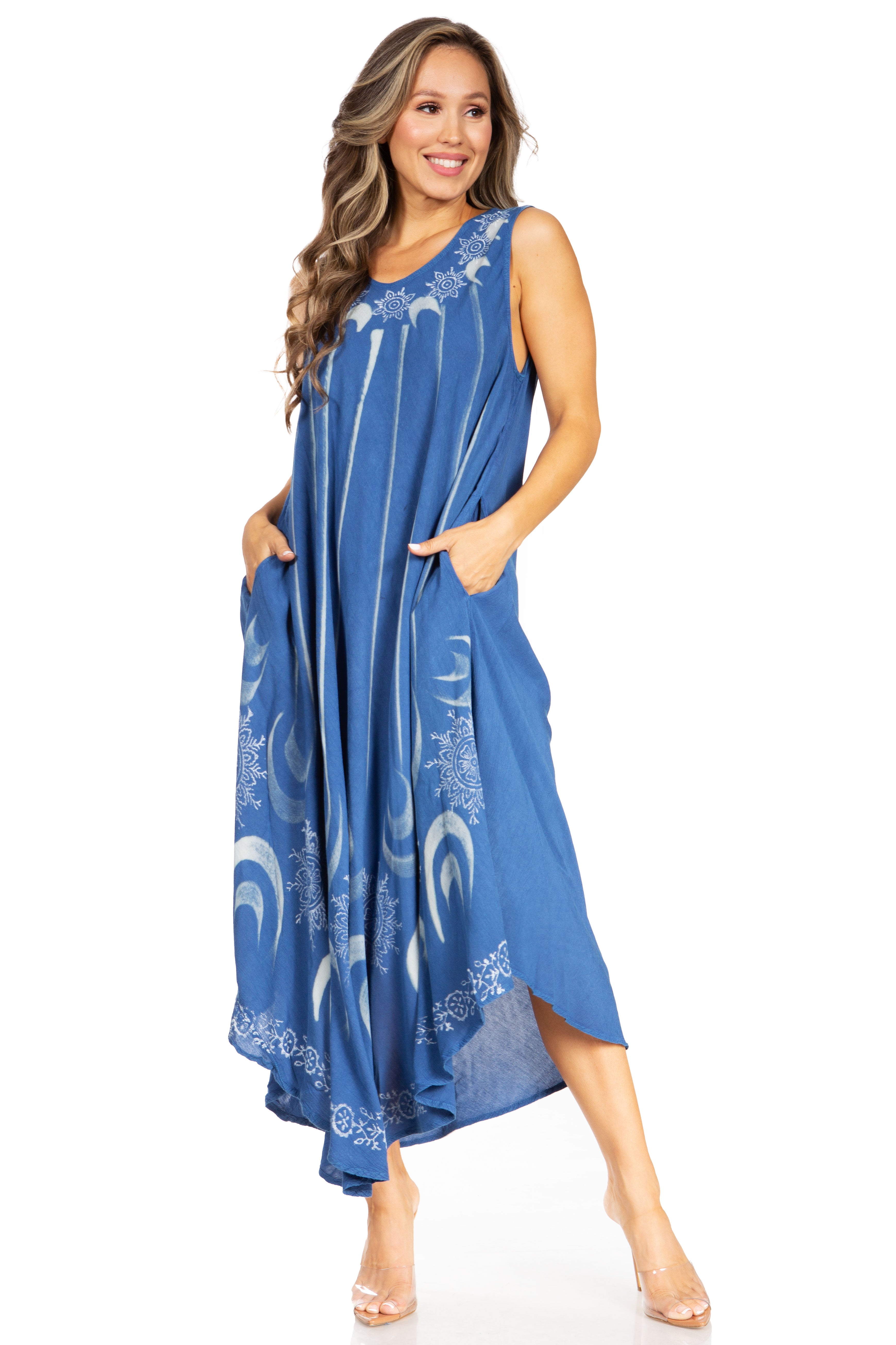 Woman wearing a blue dress with white patterns on a white background