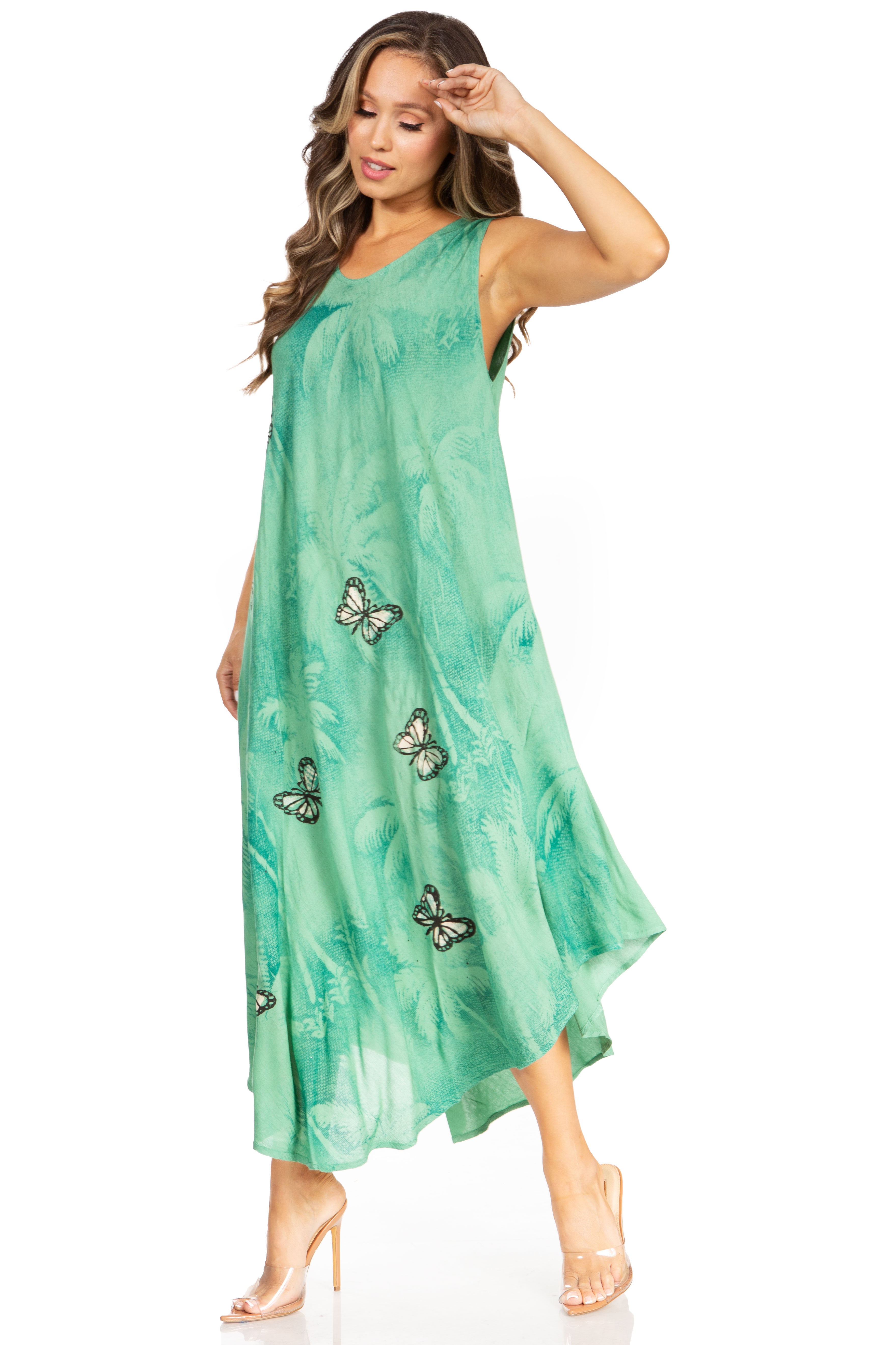 Woman wearing a green dress with butterfly patterns on a white background