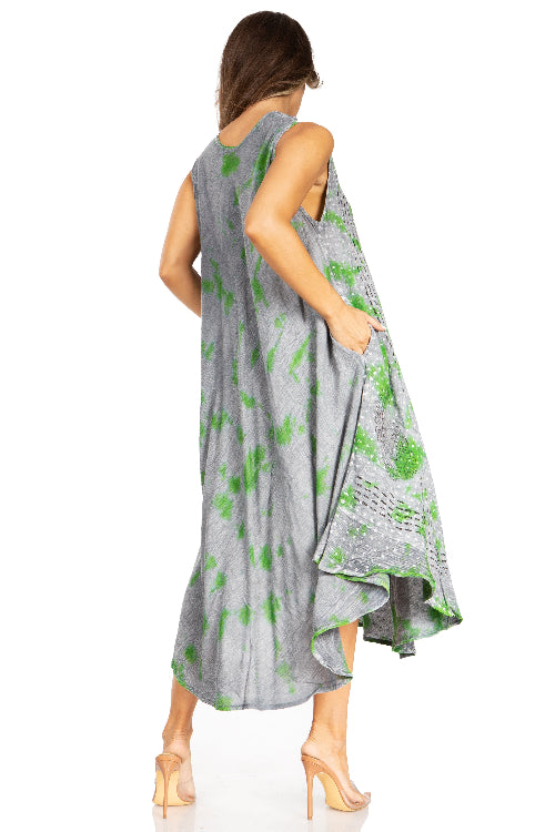 Woman wearing a gray dress with green floral patterns on a white background