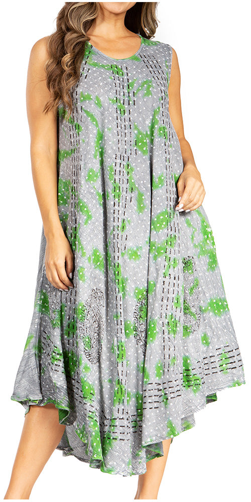 Woman wearing a sleeveless dress with green floral pattern on a white background