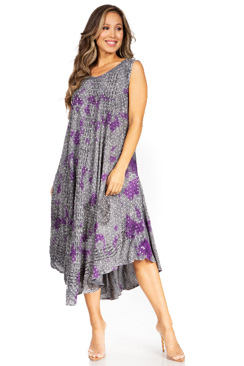 Woman wearing a gray dress with purple floral pattern on a white background