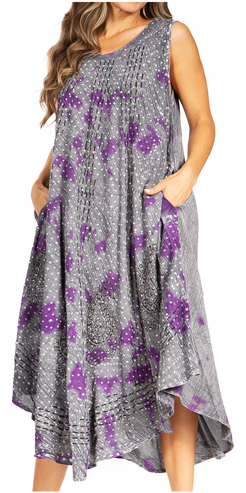 Woman wearing a gray dress with purple floral pattern on a white background
