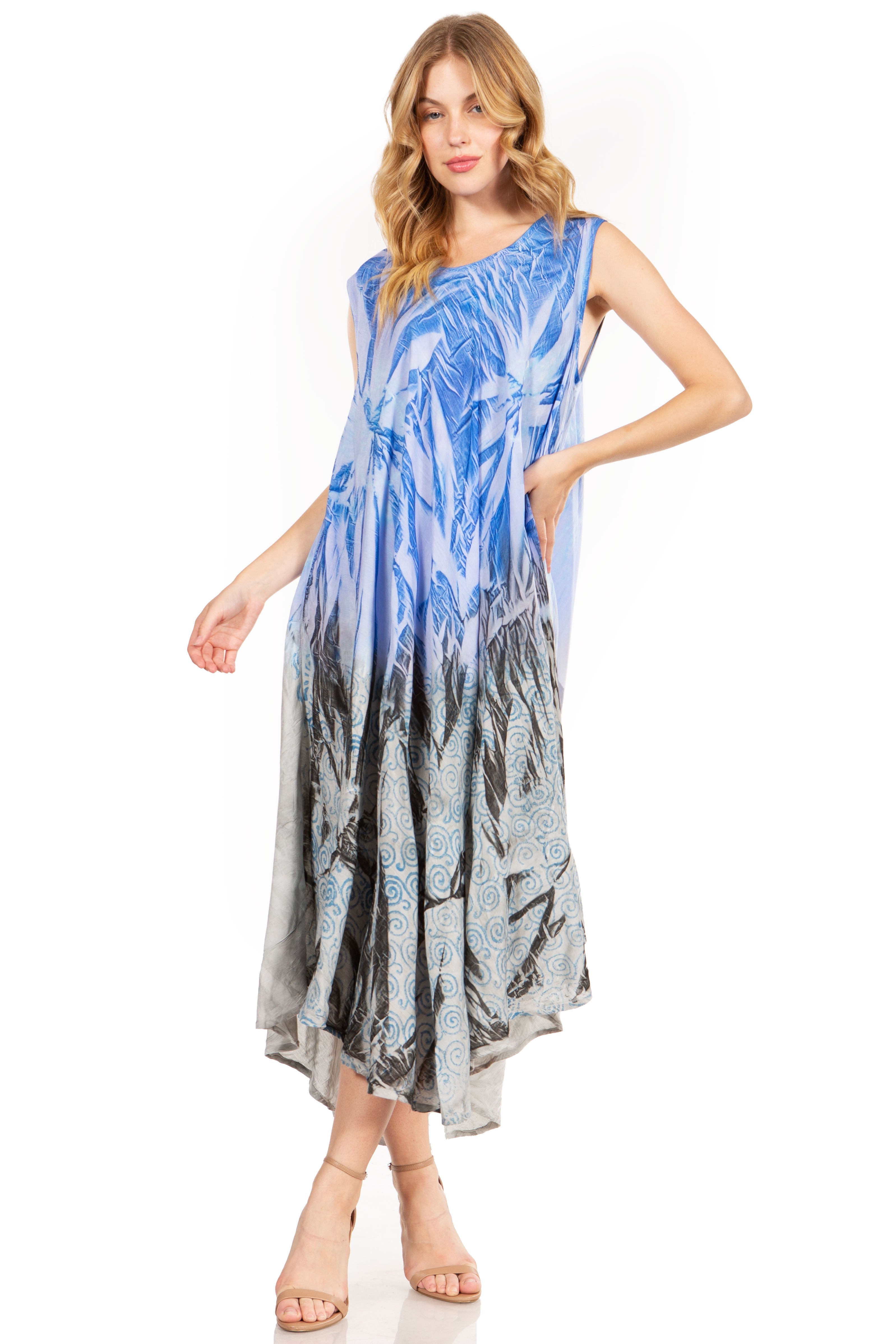 Woman wearing a sleeveless dress with a blue and gray pattern on a white background