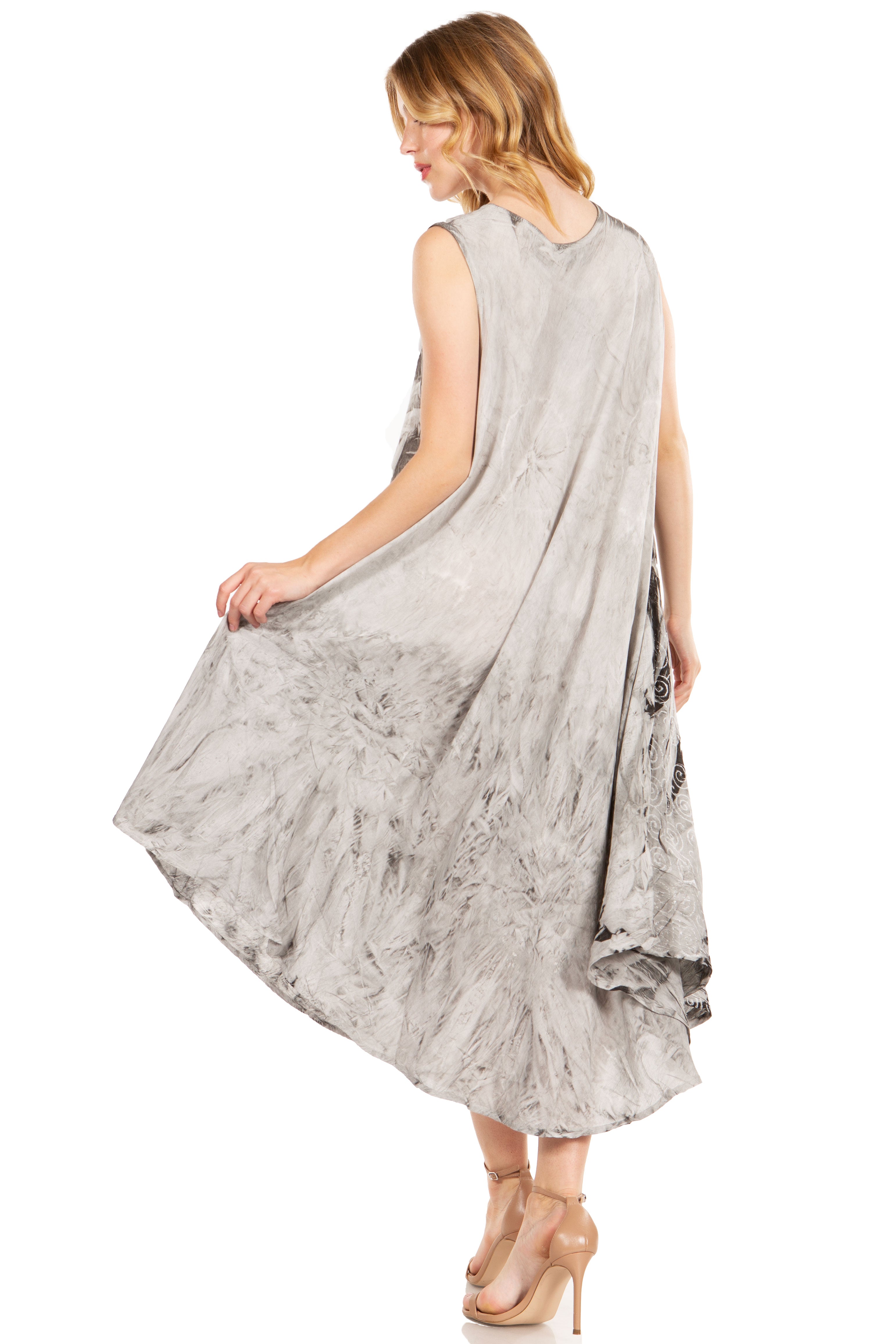Woman wearing a gray sleeveless dress with a textured pattern on a white background