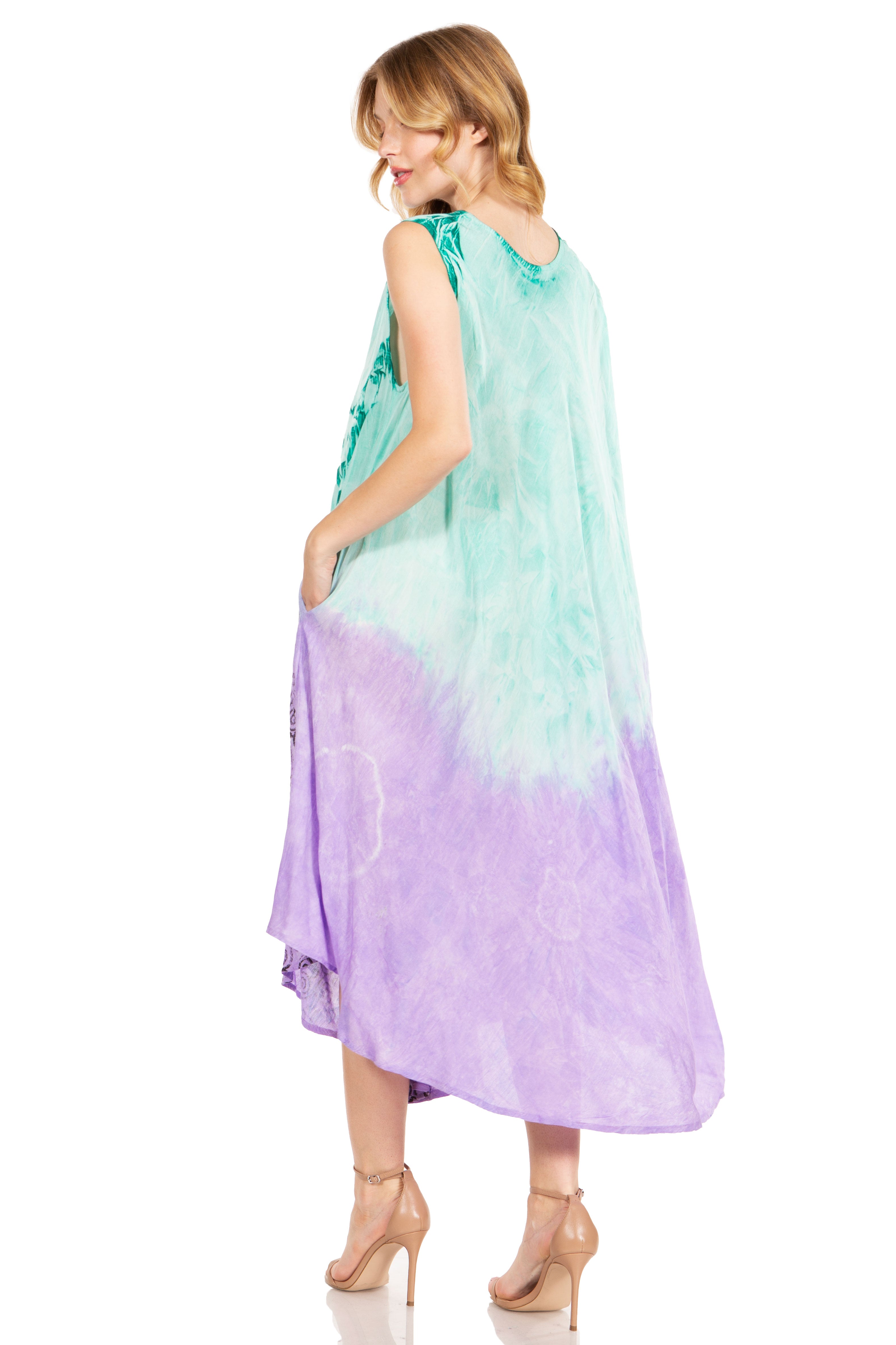 Woman wearing a colorful dress with a gradient from green to purple on a white background