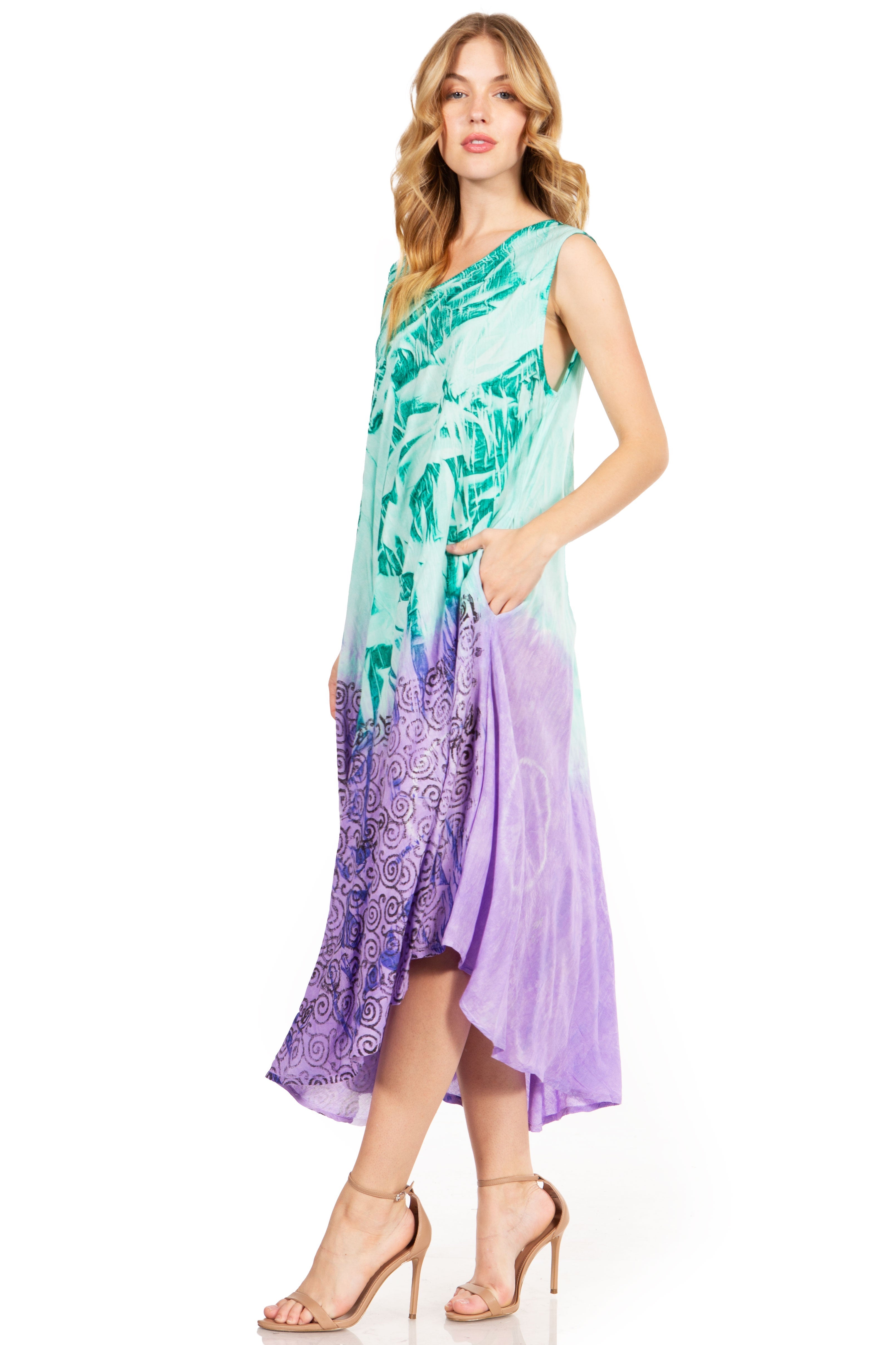 Woman wearing a colorful dress with a green and purple pattern on a white background