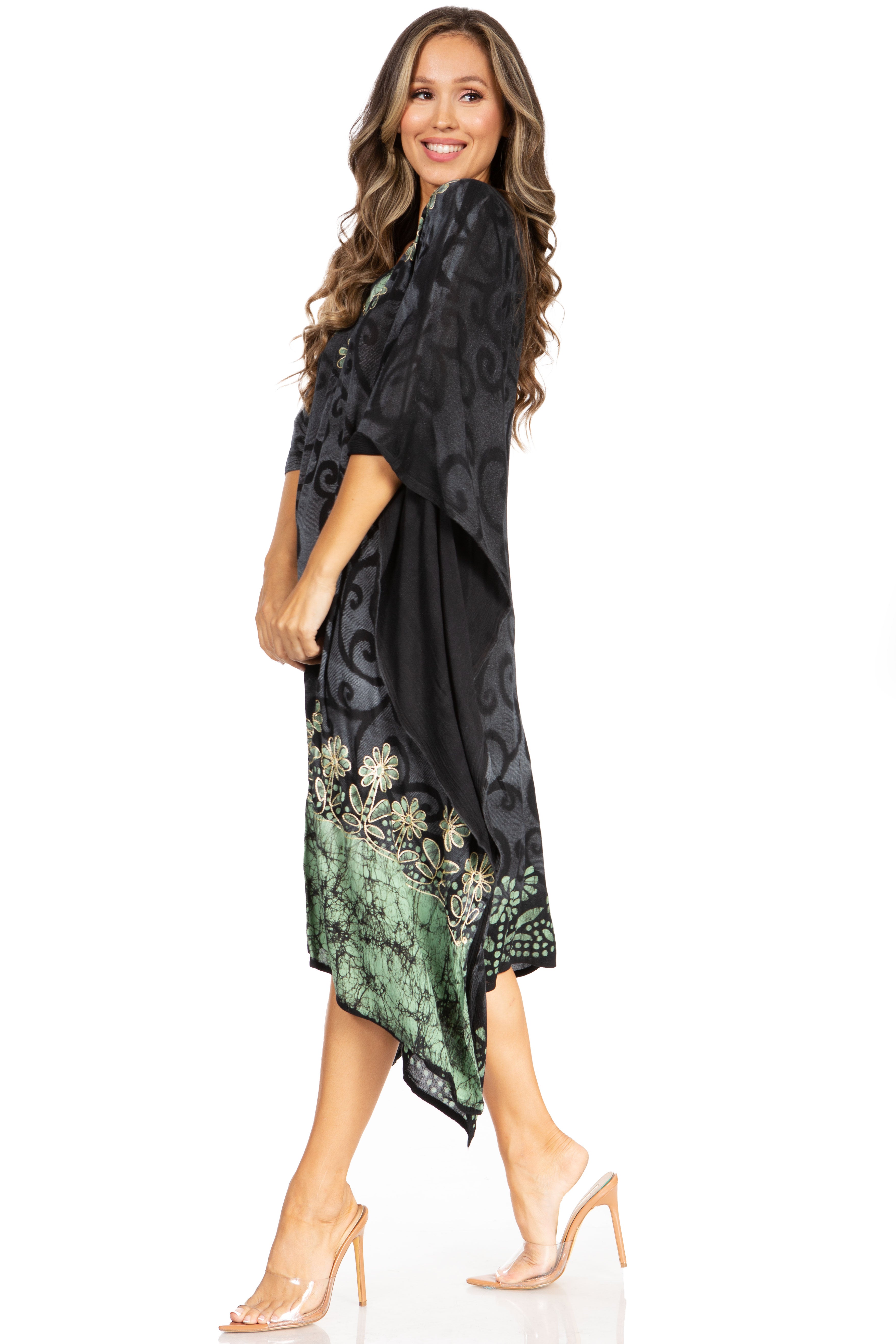 Woman wearing a black and green patterned dress on a white background