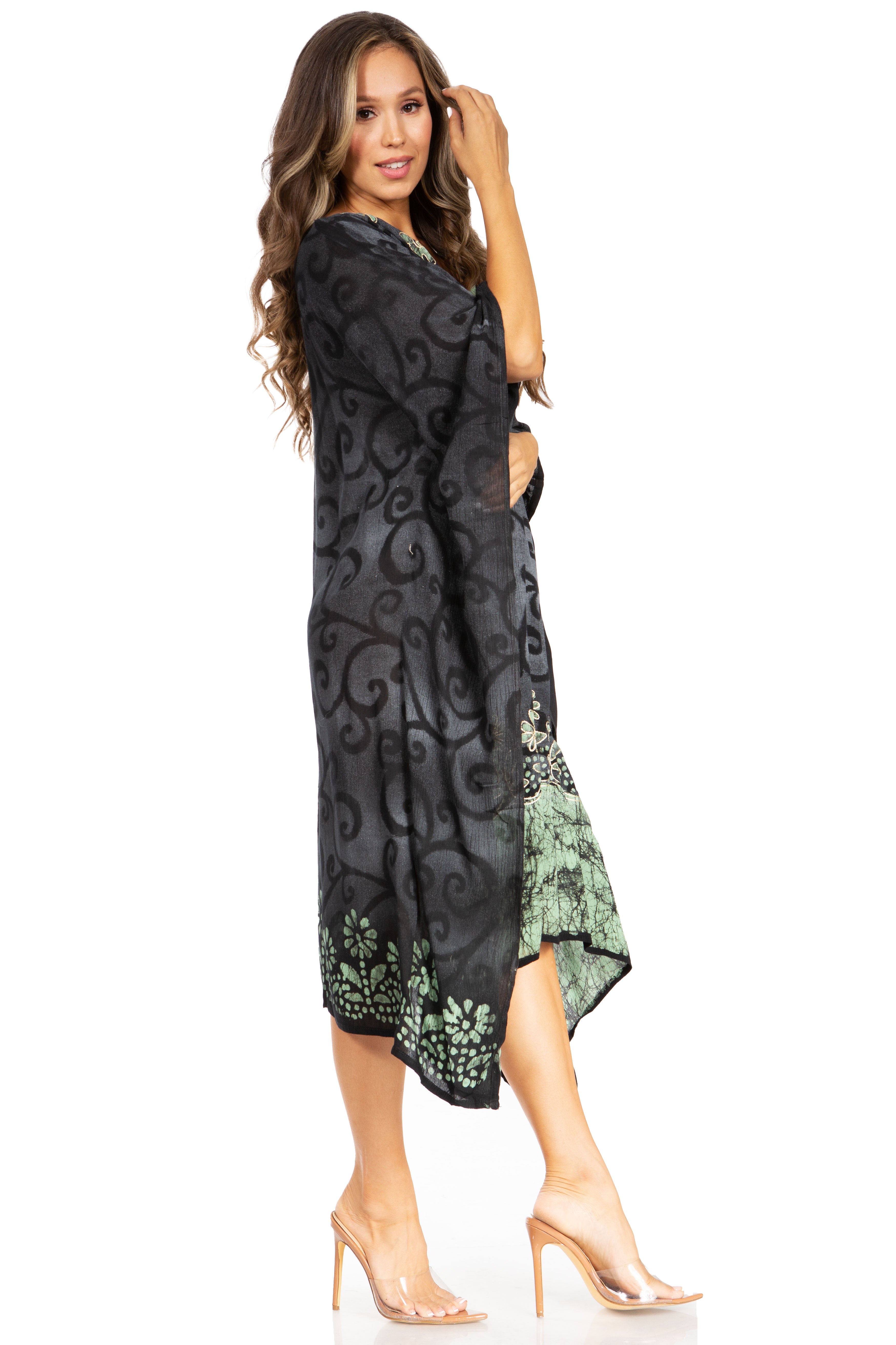 Woman wearing a black and green patterned dress on a white background