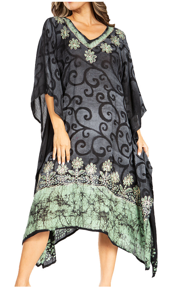 Woman wearing a black and green patterned dress with a white background