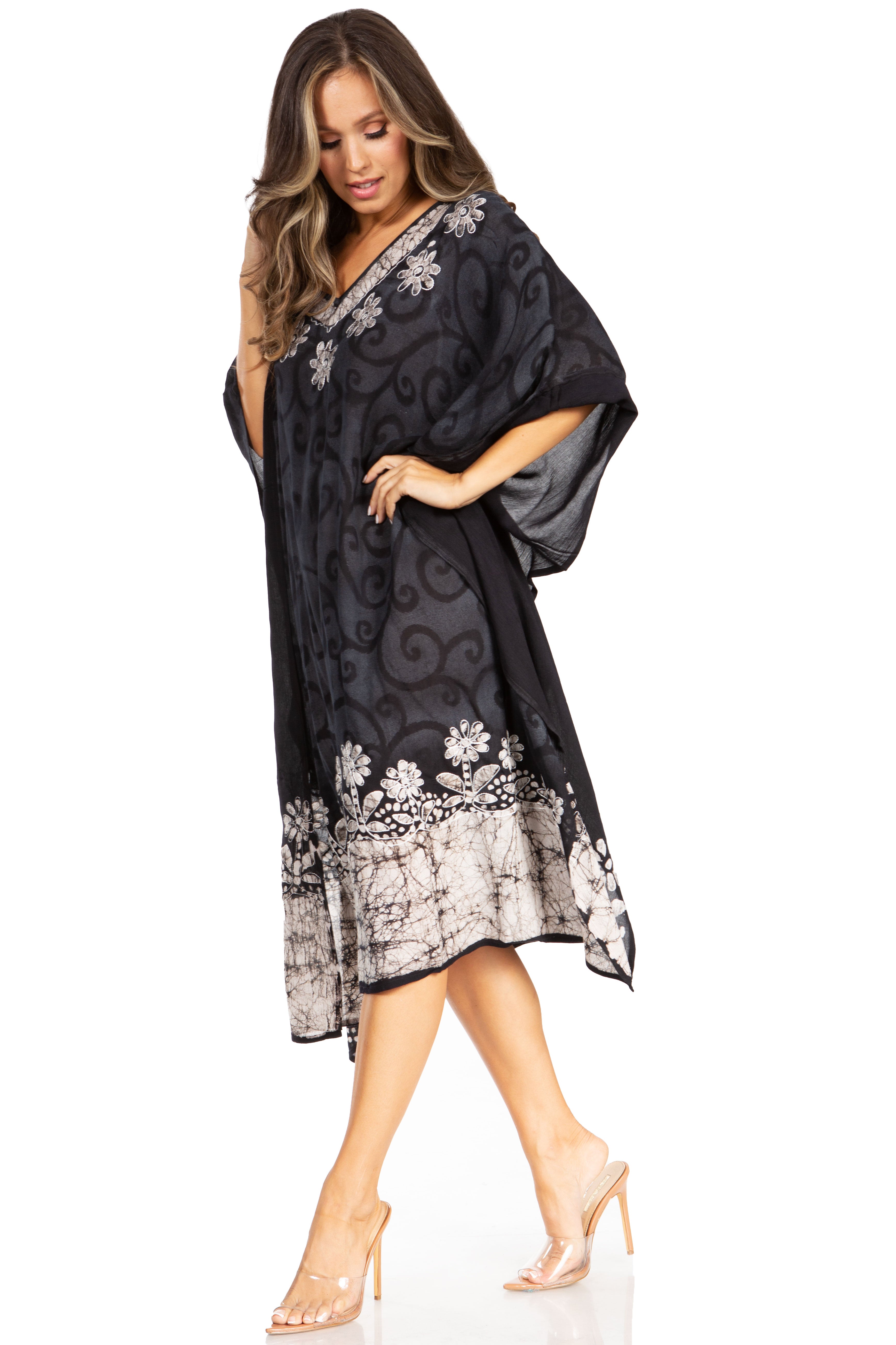 Woman wearing a black floral patterned dress on a white background