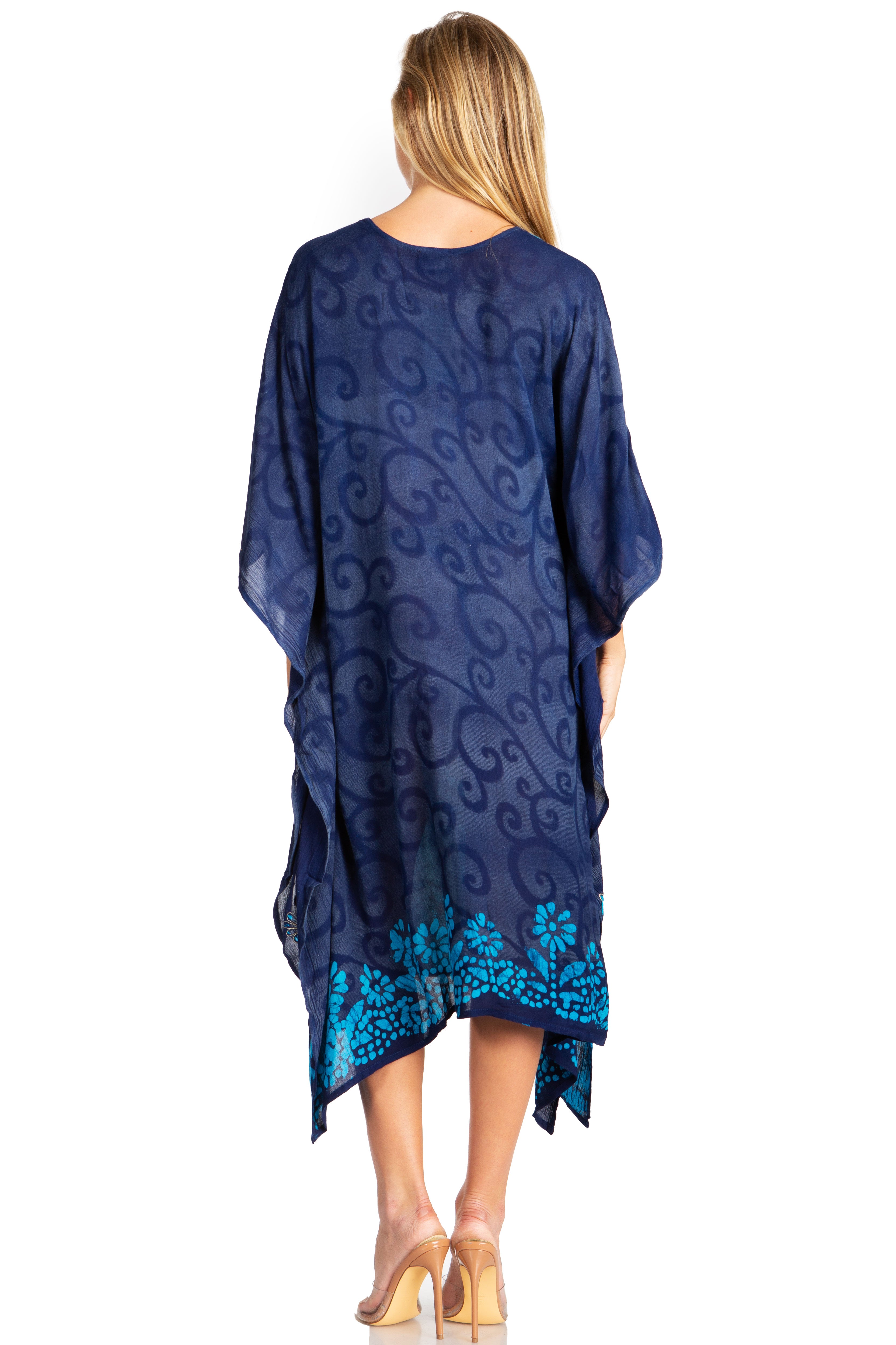 Woman wearing a blue patterned dress with a white background