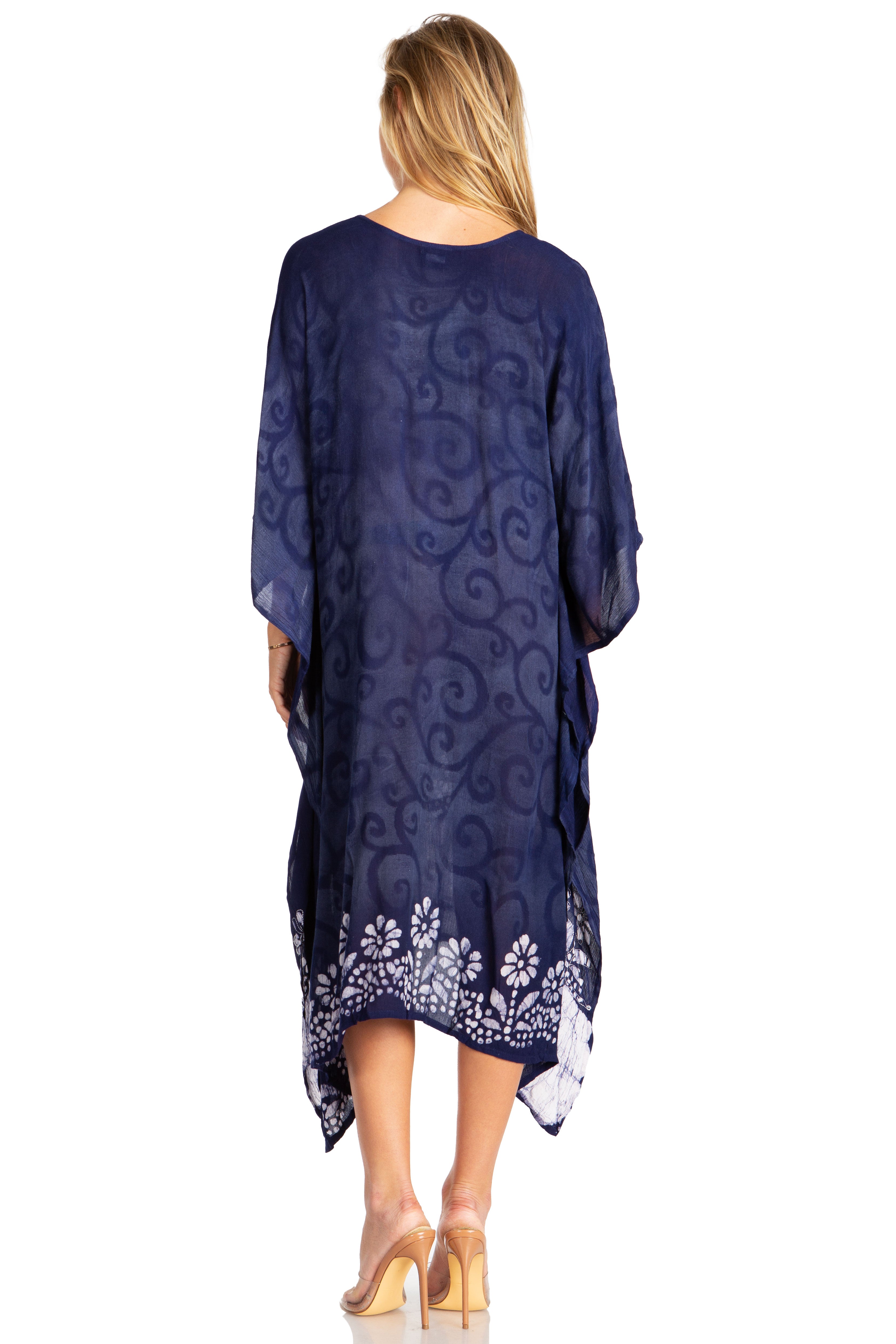 Woman wearing a blue patterned dress with a white background