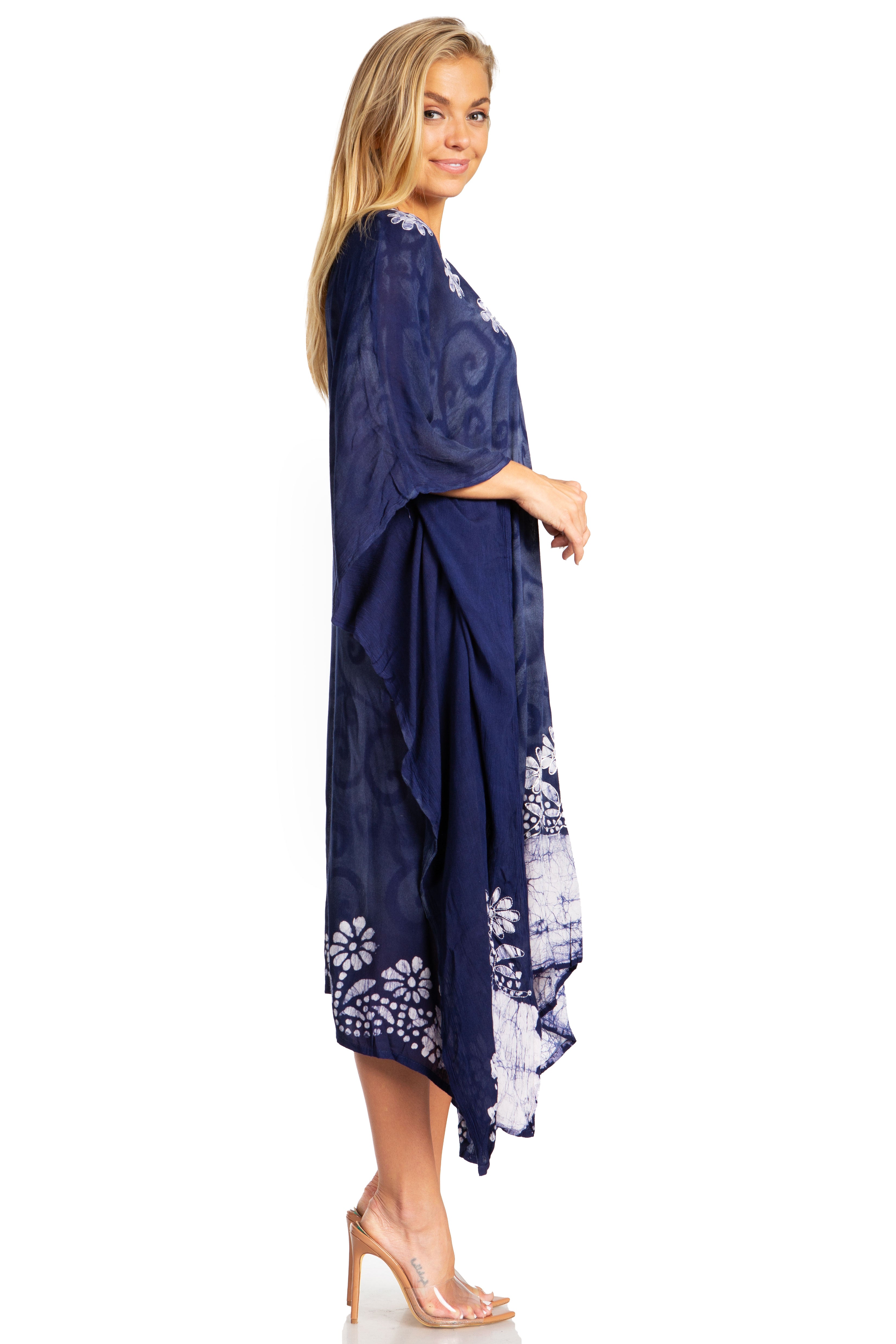 Woman wearing a navy blue dress with white floral patterns on a white background