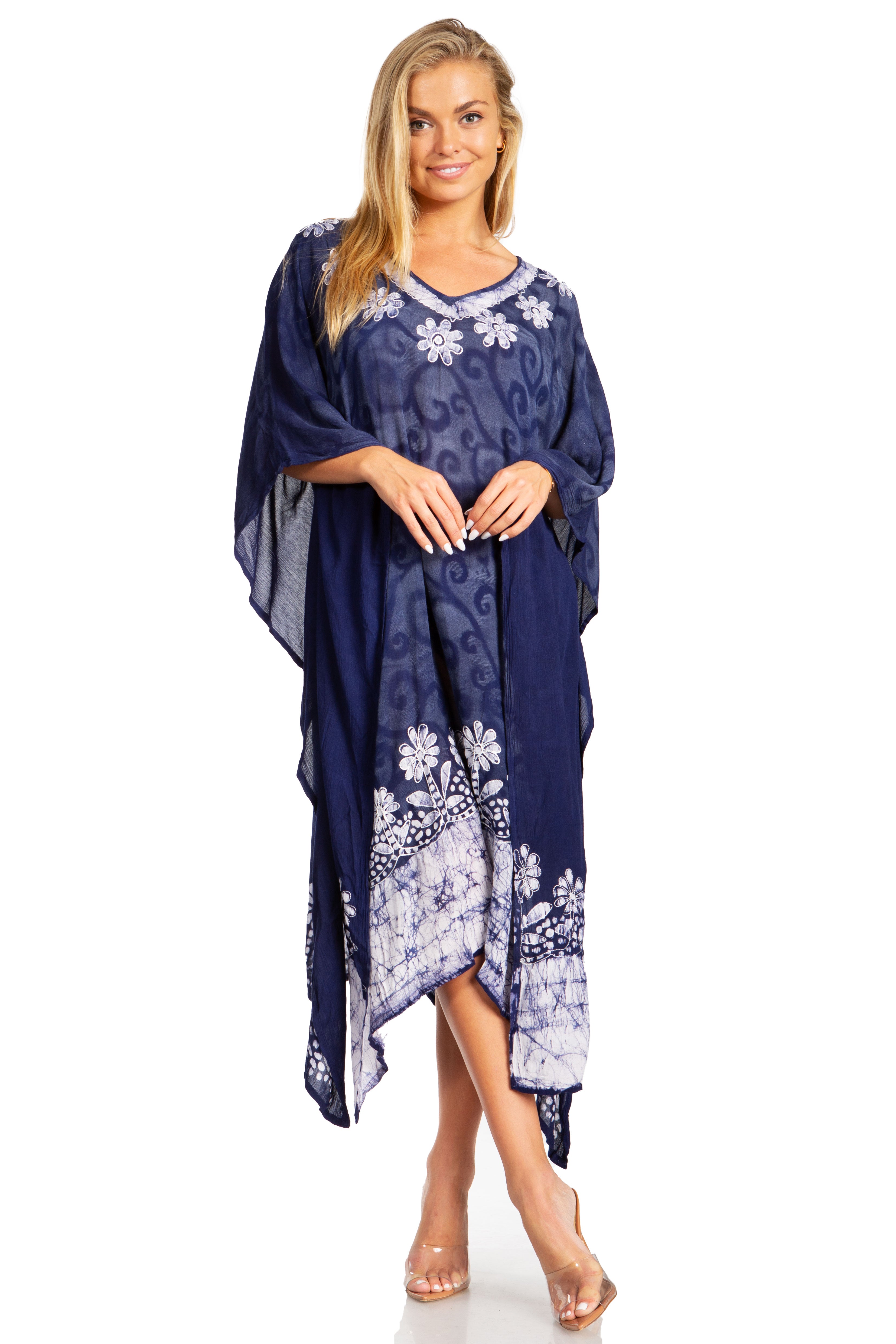 Woman wearing a navy blue dress with white floral patterns on a white background
