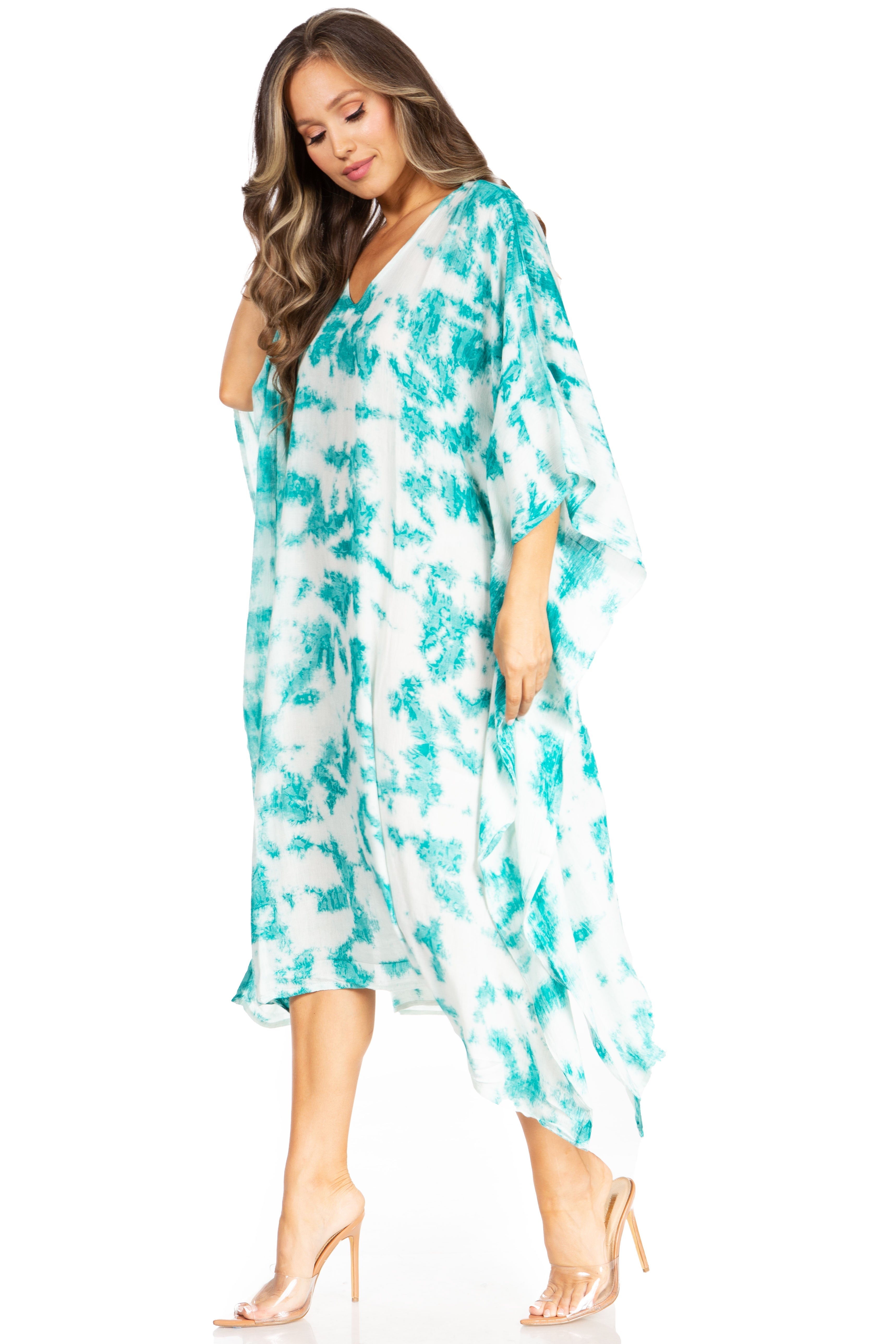 Woman wearing a turquoise and white patterned dress on a white background